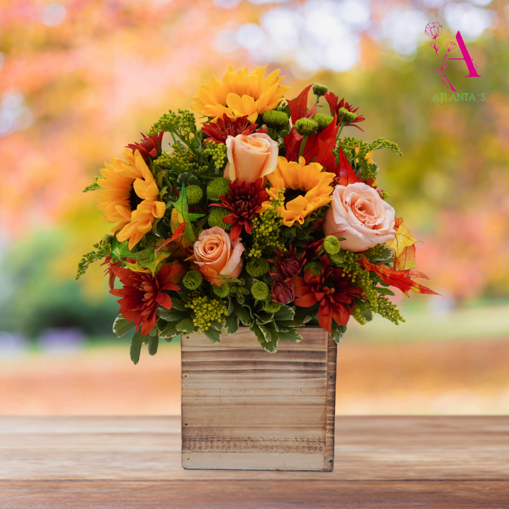Autumn floral arrangement with sunflowers, roses, and red mums in a wooden box
