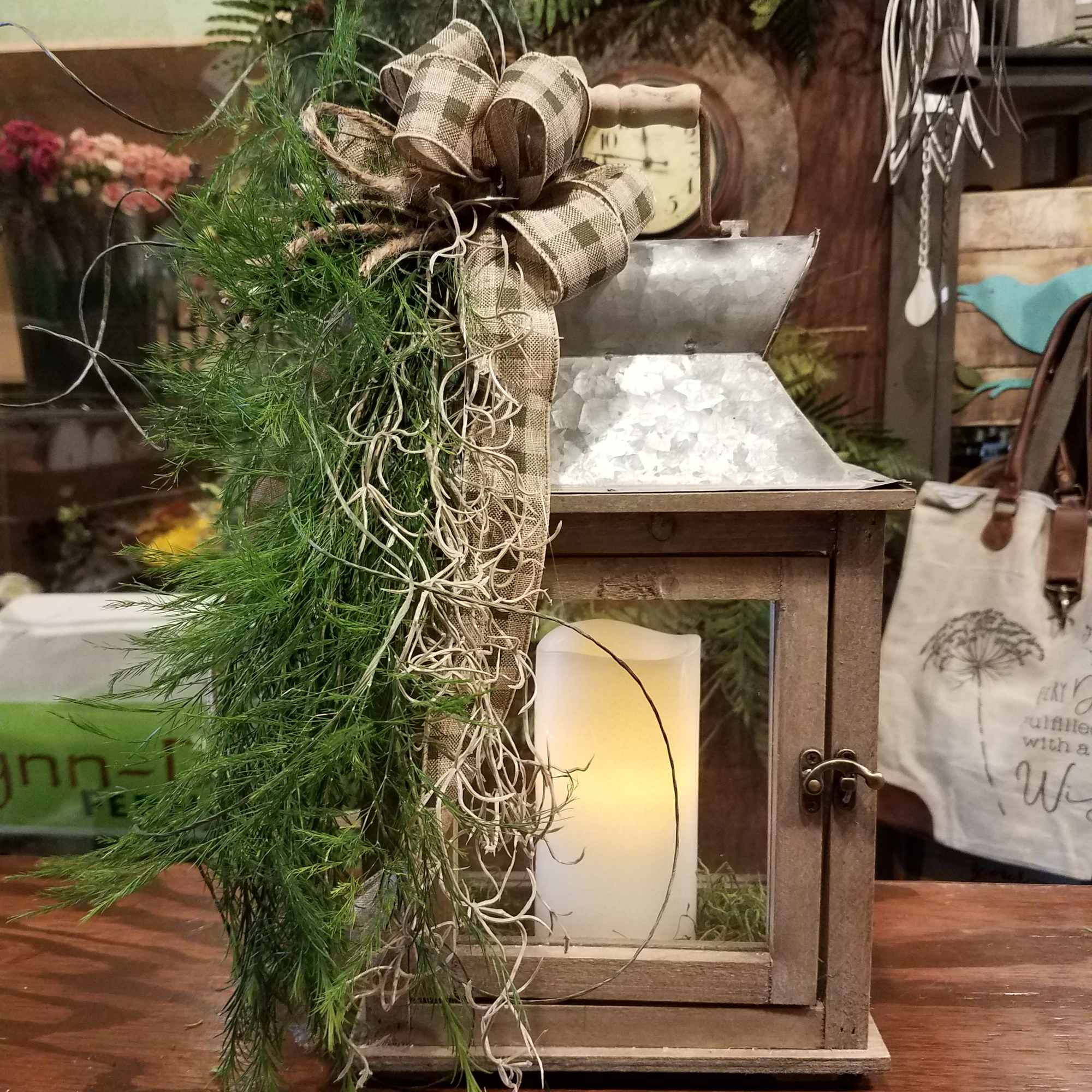 Rustic lantern with greenery and a plaid bow