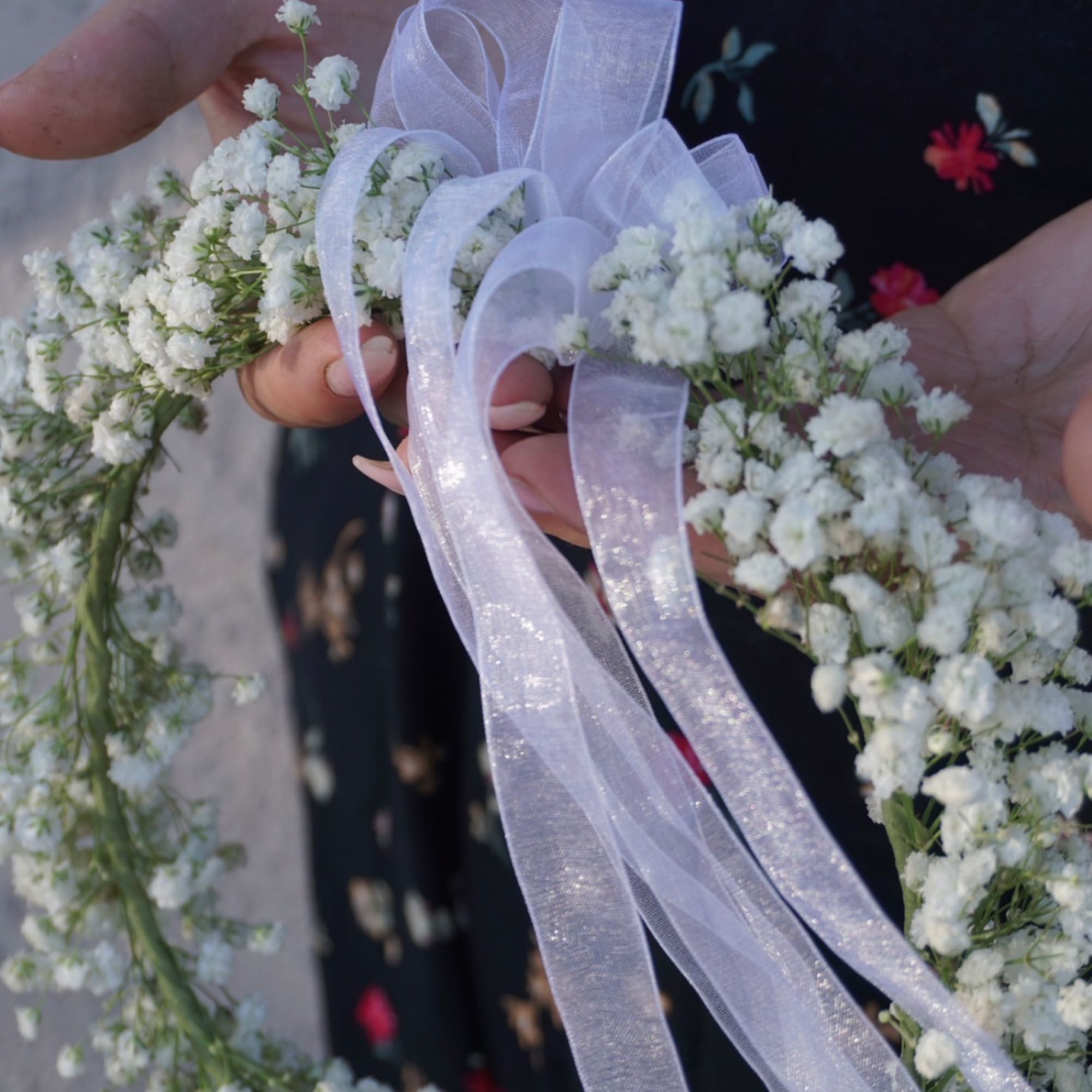 White baby's breath wreath with a sheer lavender ribbon