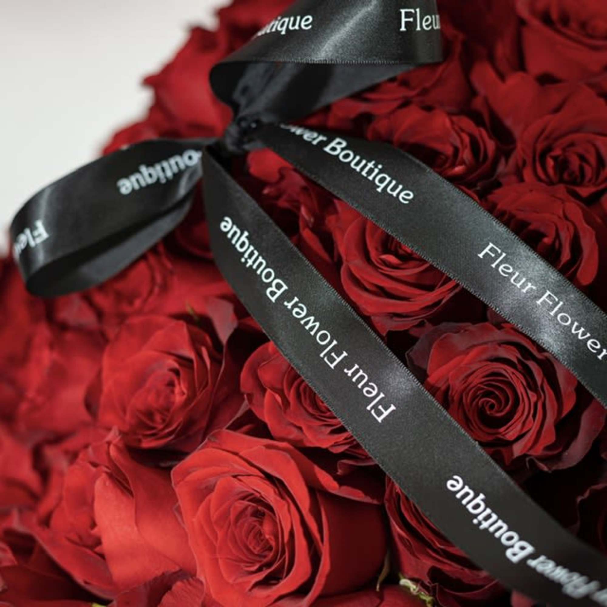 Bouquet of red roses tied with black ribbon