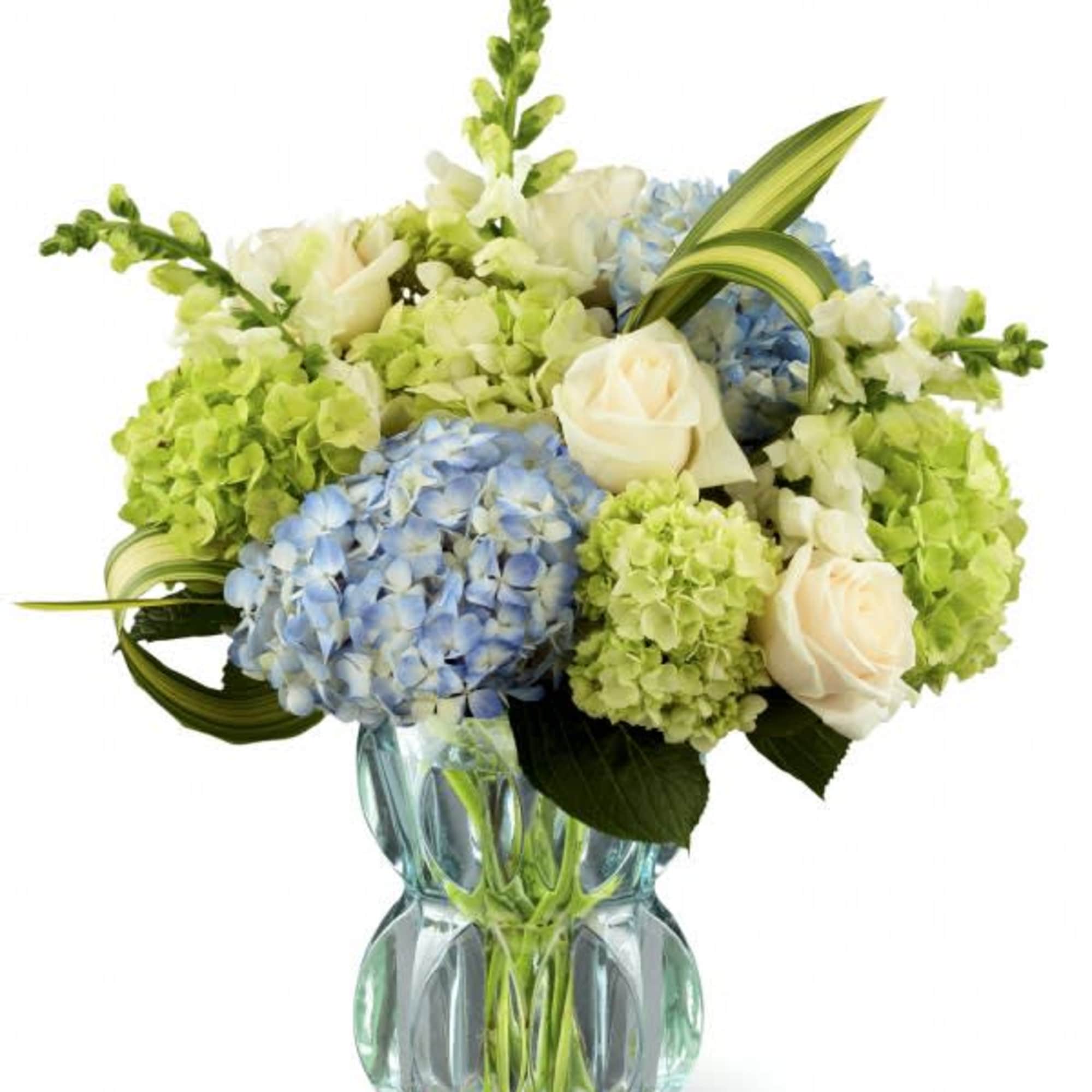 Clusters of blue and green hydrangea give this floral arrangement a fresh