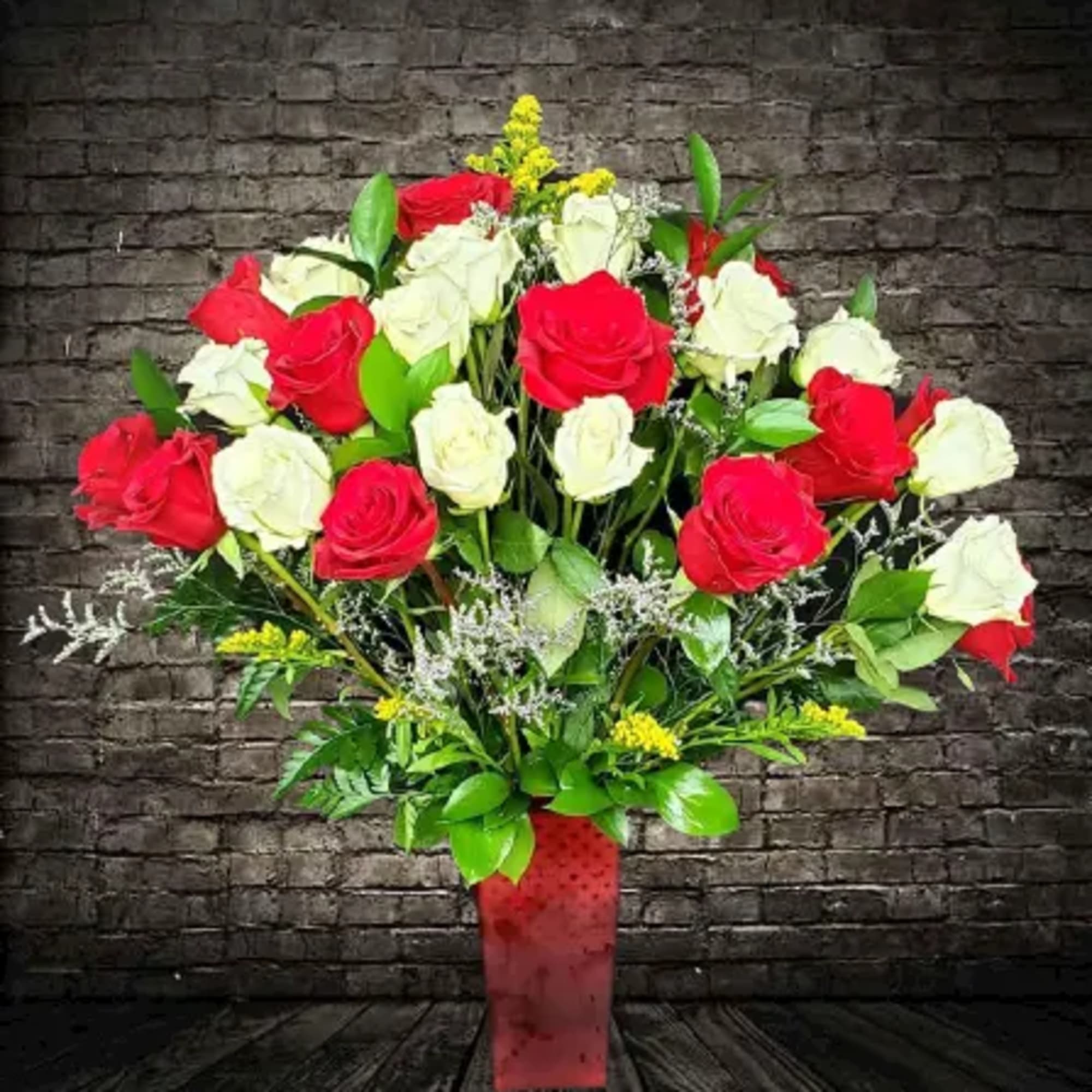 Bouquet of red and white roses in a red vase