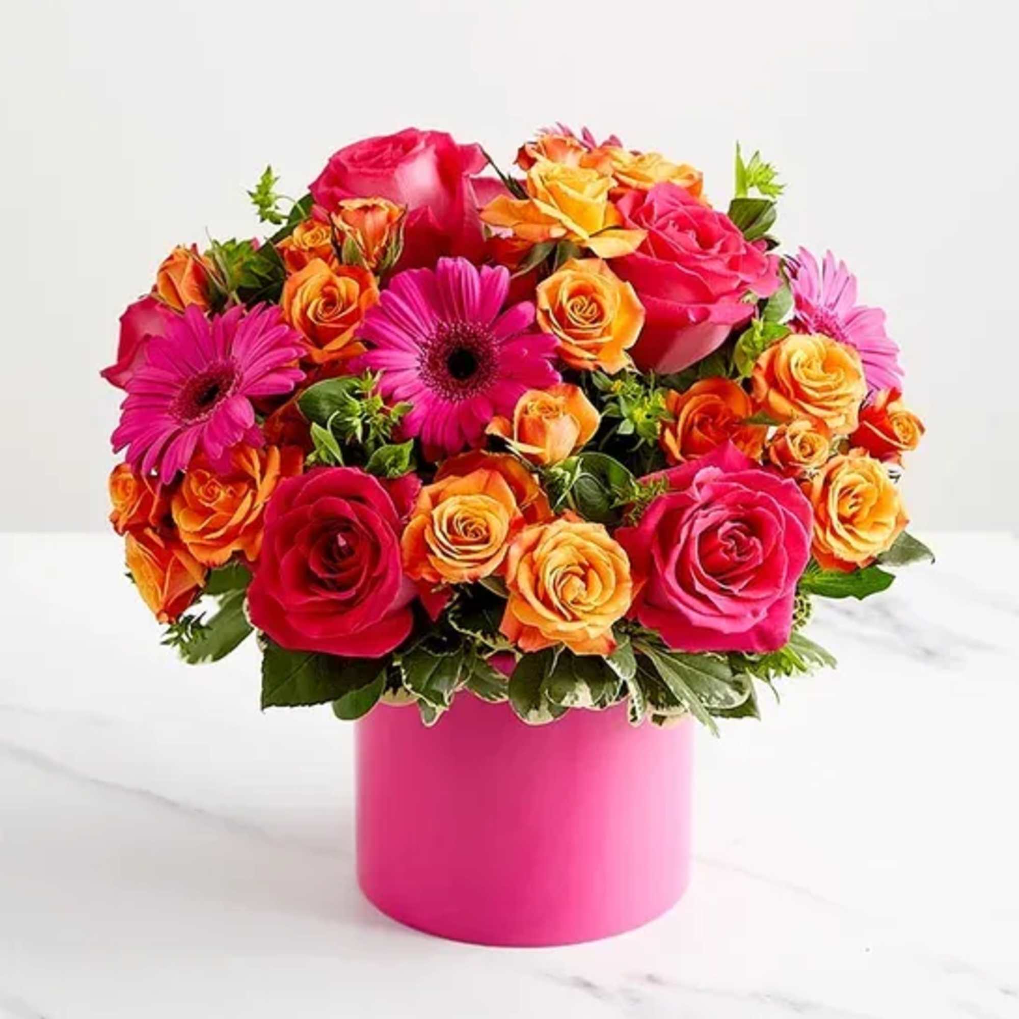 Bouquet of pink and orange roses with magenta daisies in a pink vase
