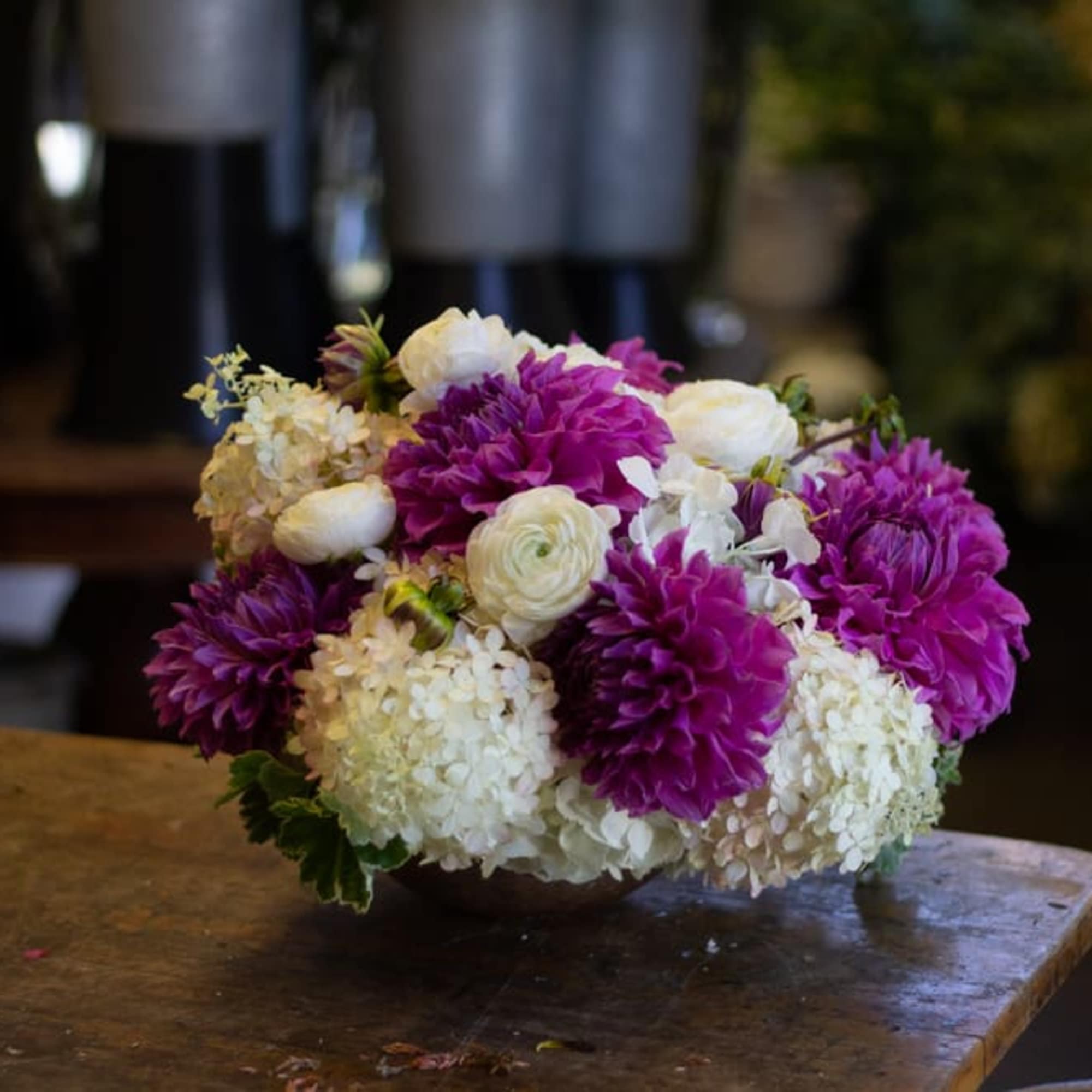 Low arrangement of purple and white flowers in a bowl