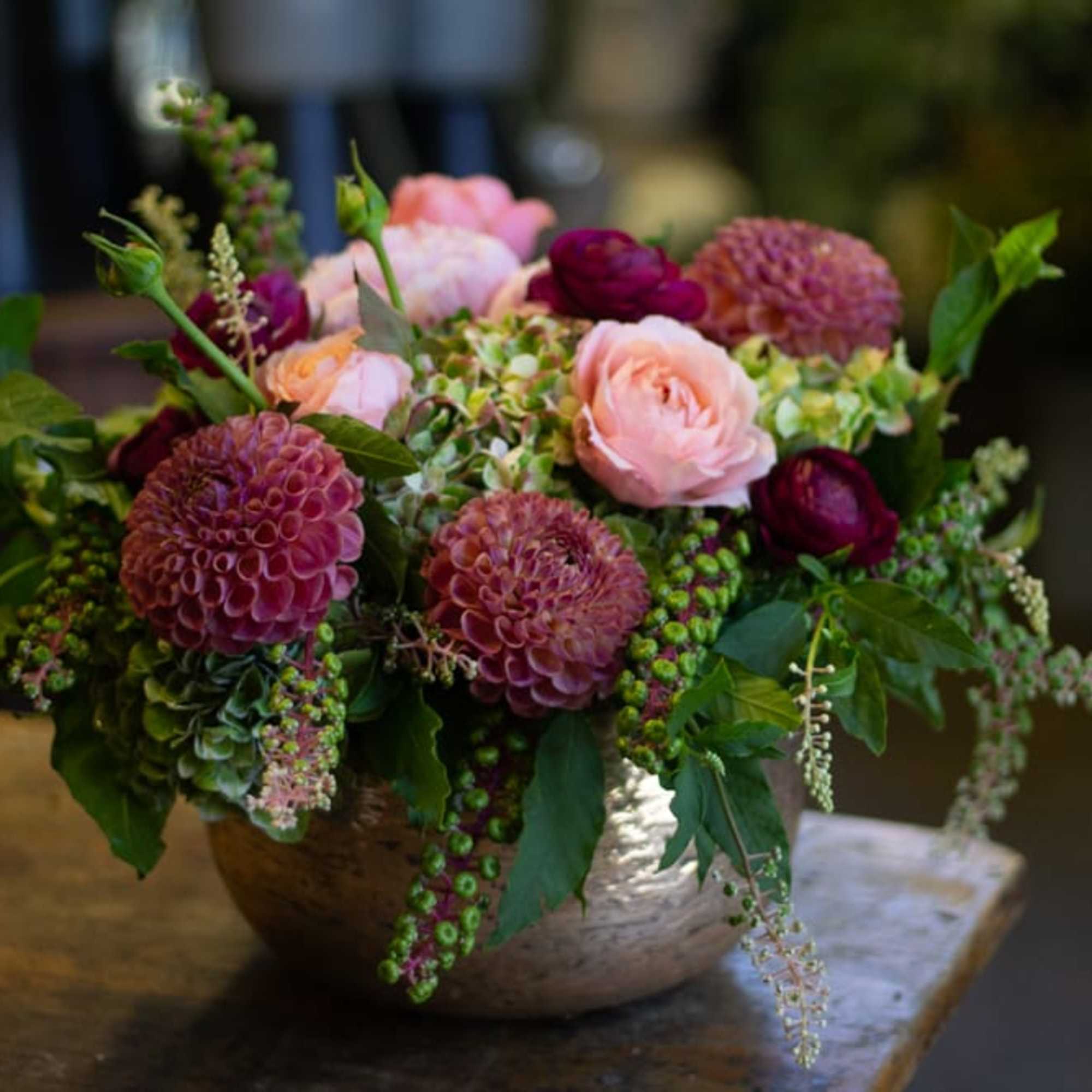 A bountiful arrangement of several large headed pink and purple flowers. 