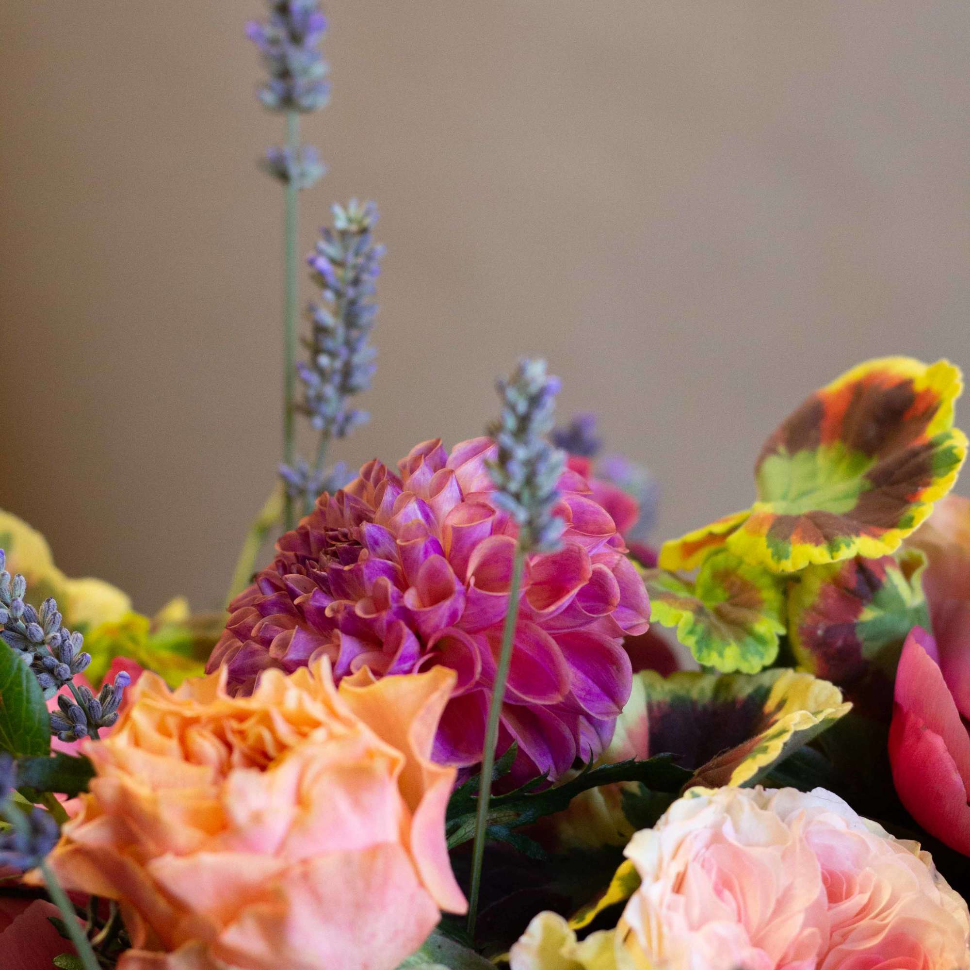 Colorful bouquet with pink and peach blooms and purple spikes