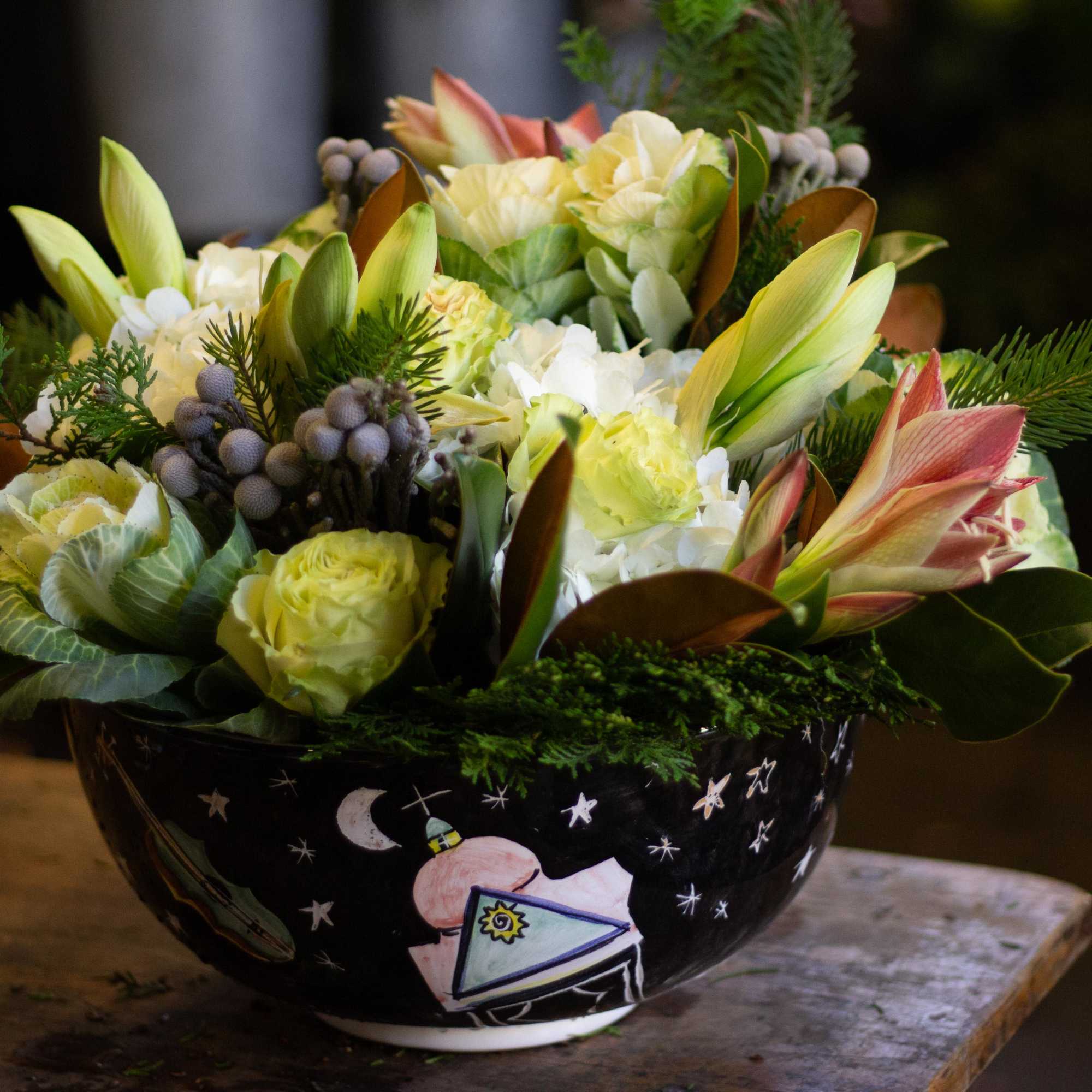 This is a very lush arrangement with holiday textures such as magnolia
