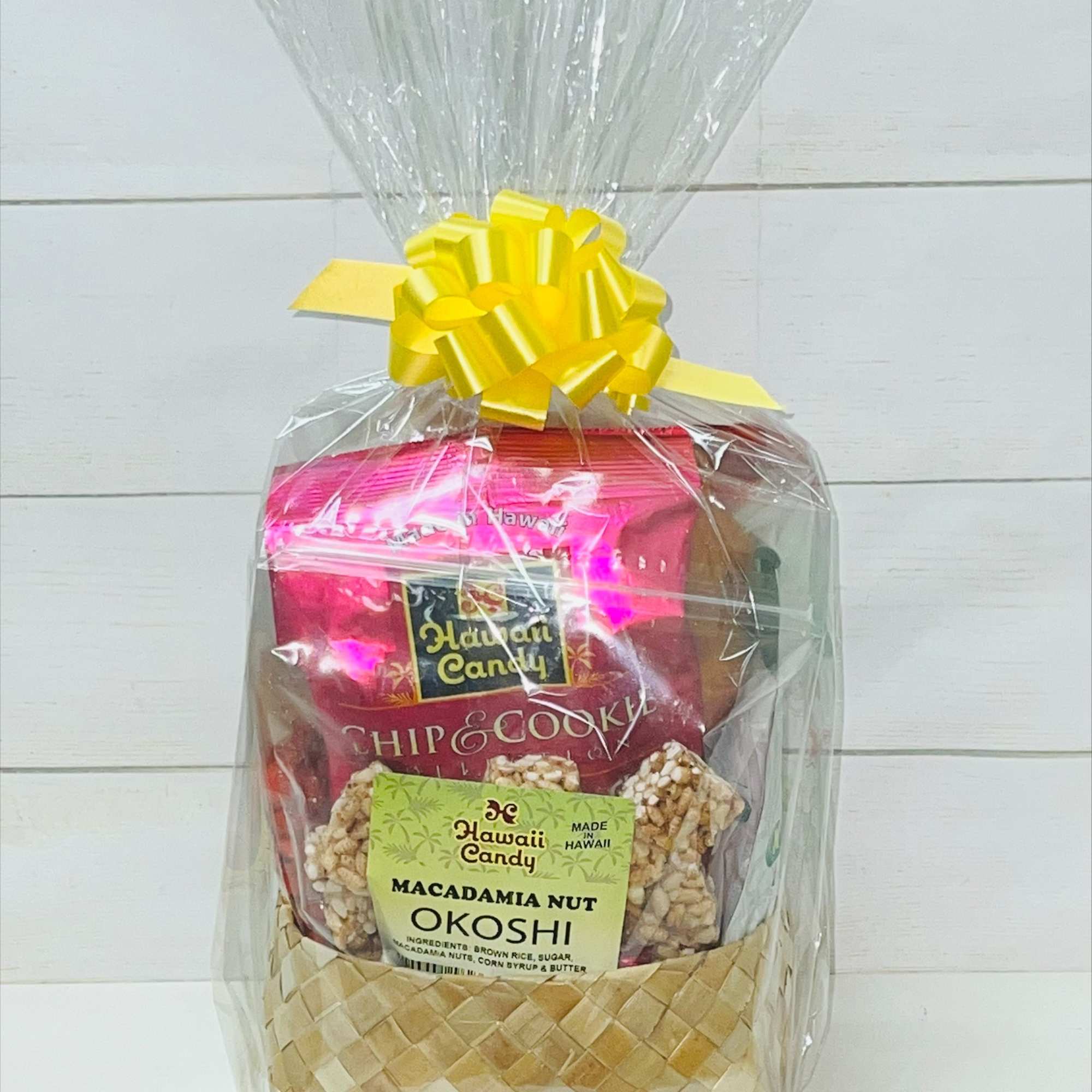 Gift basket of Hawaiian snacks wrapped in clear cellophane with a yellow bow