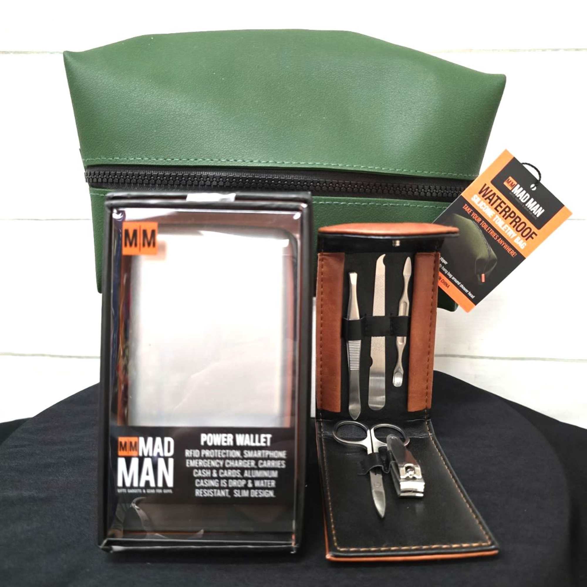 Men's grooming gift set with green toiletry bag, power wallet, and manicure kit in leather case