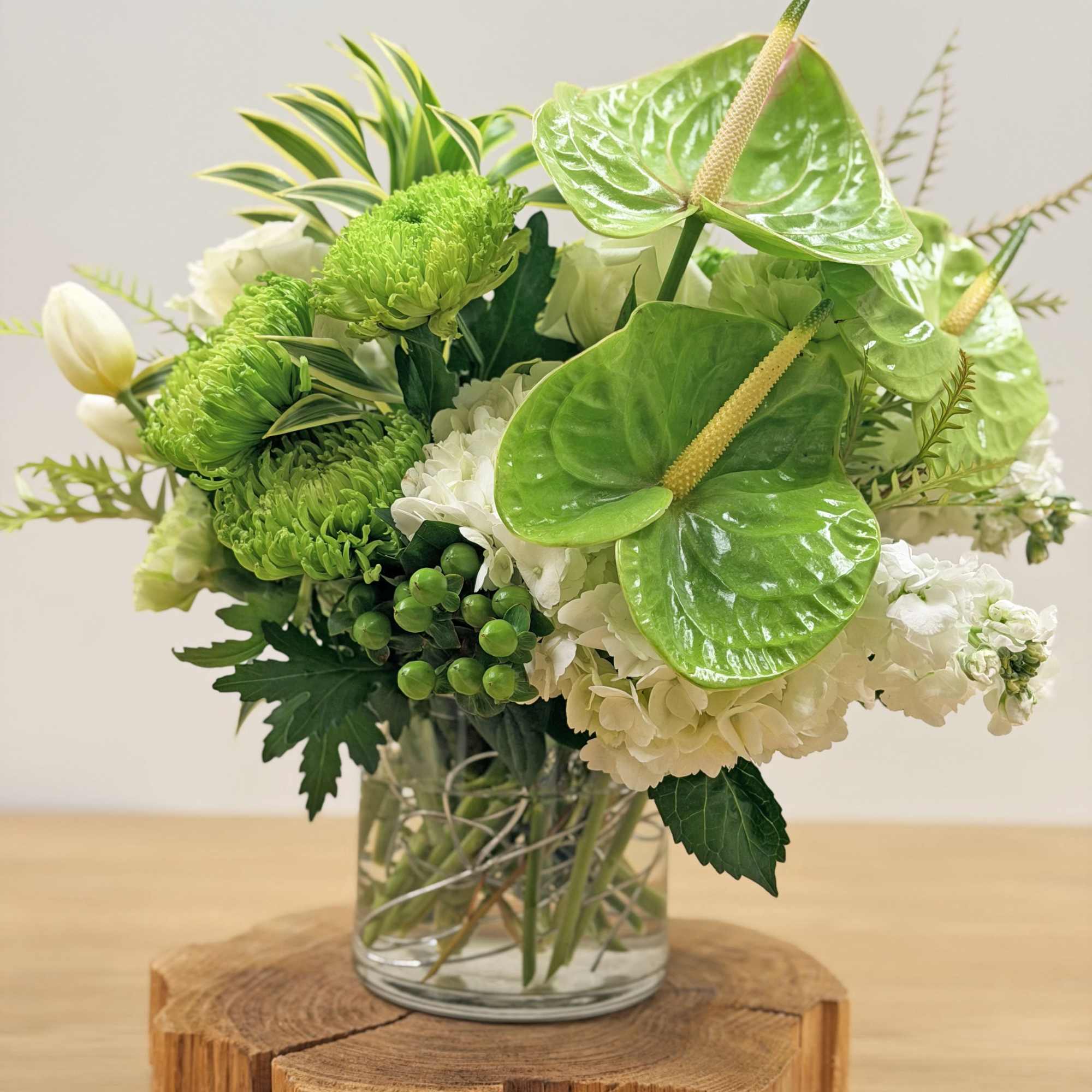 Lush glossy anthurium and cloud-like white hydrangeas give this green-and-white arrangement a, photo 2 of 2