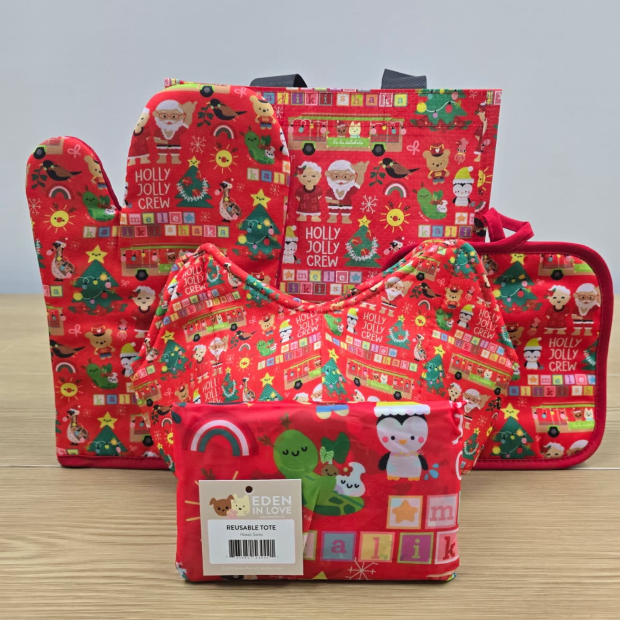 Set of red holiday reusable tote bags with festive cartoon prints