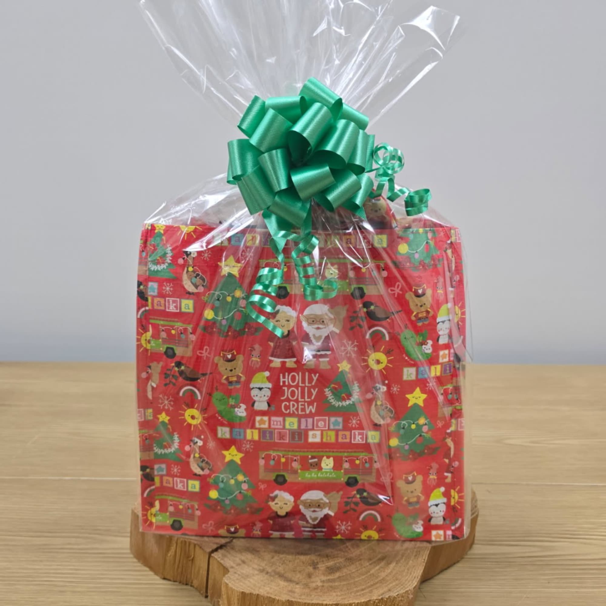Wrapped holiday gift basket with a green bow