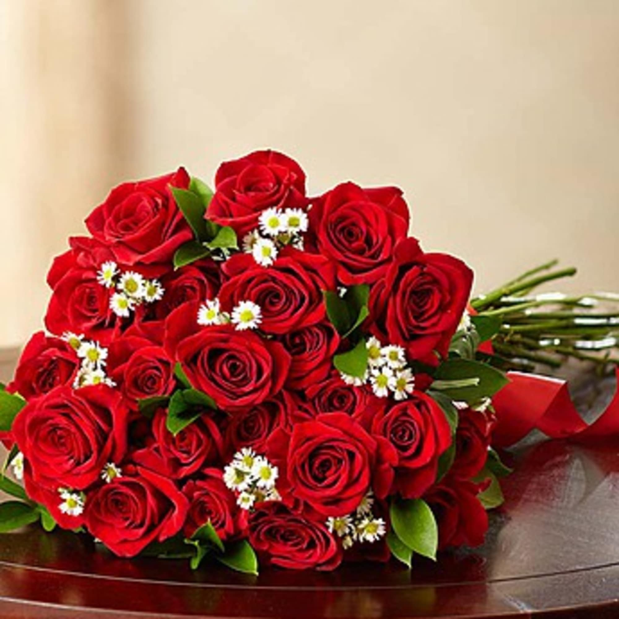 Bouquet of red roses with small white daisies