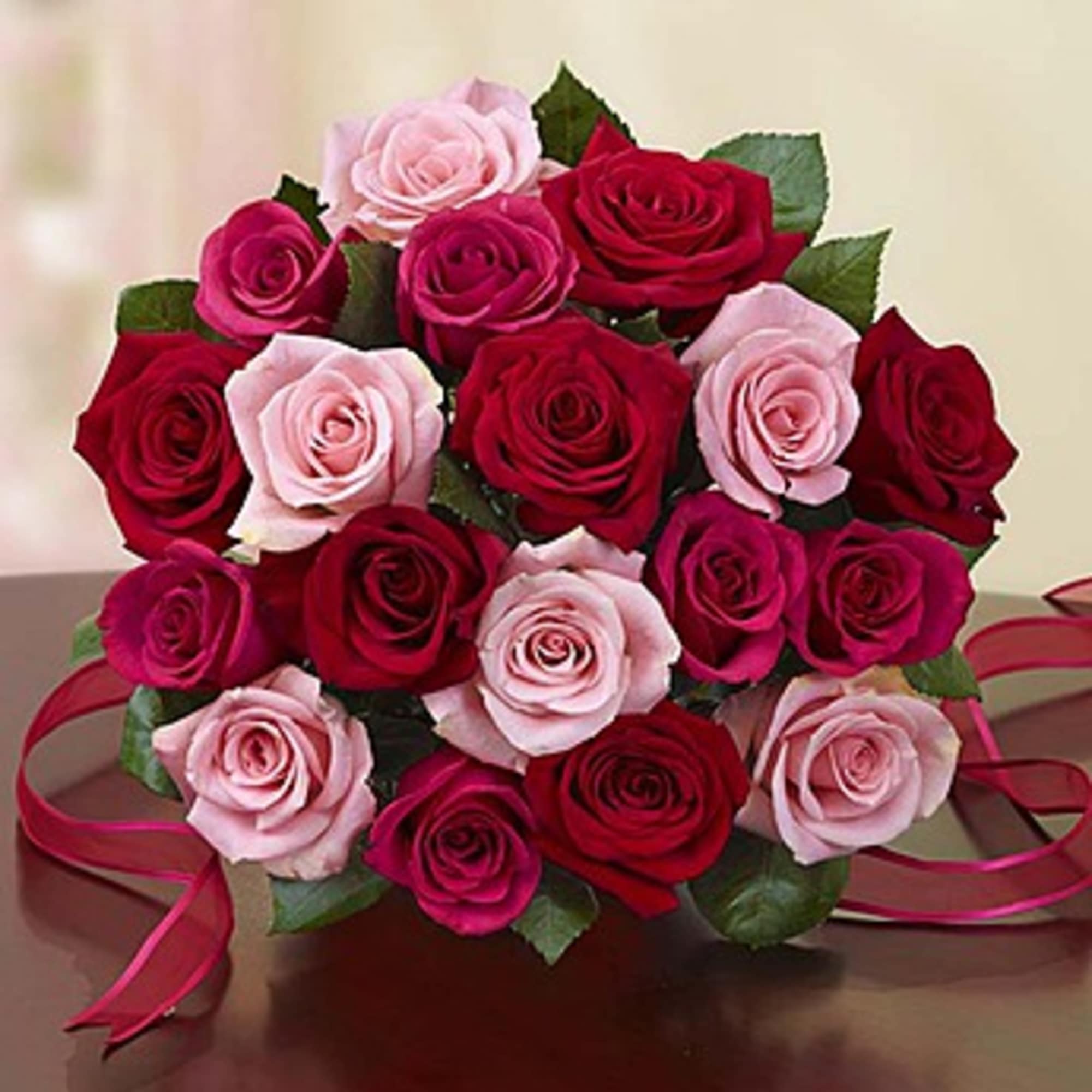 Bouquet of red and pink roses tied with ribbon