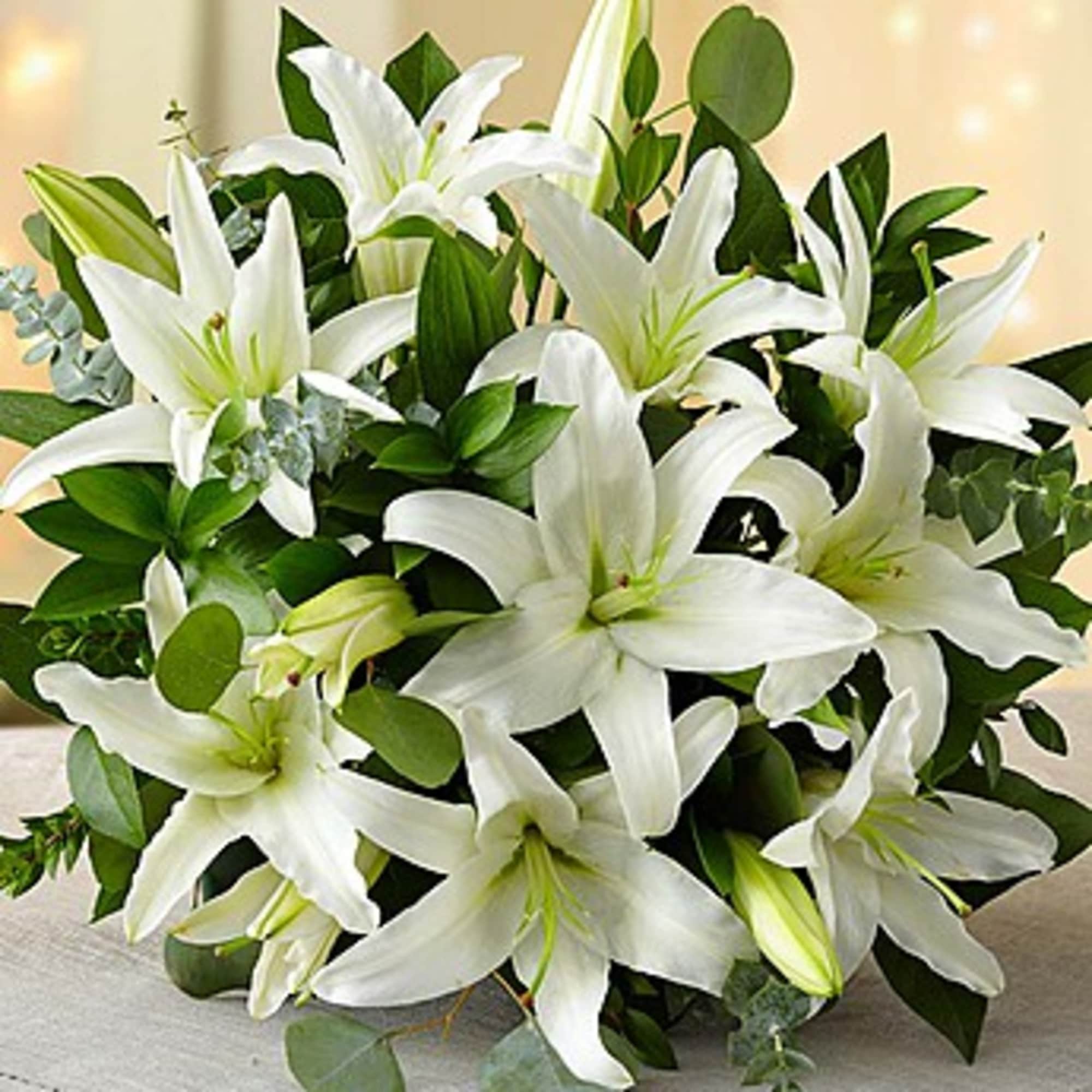 Bouquet of white lilies with green foliage