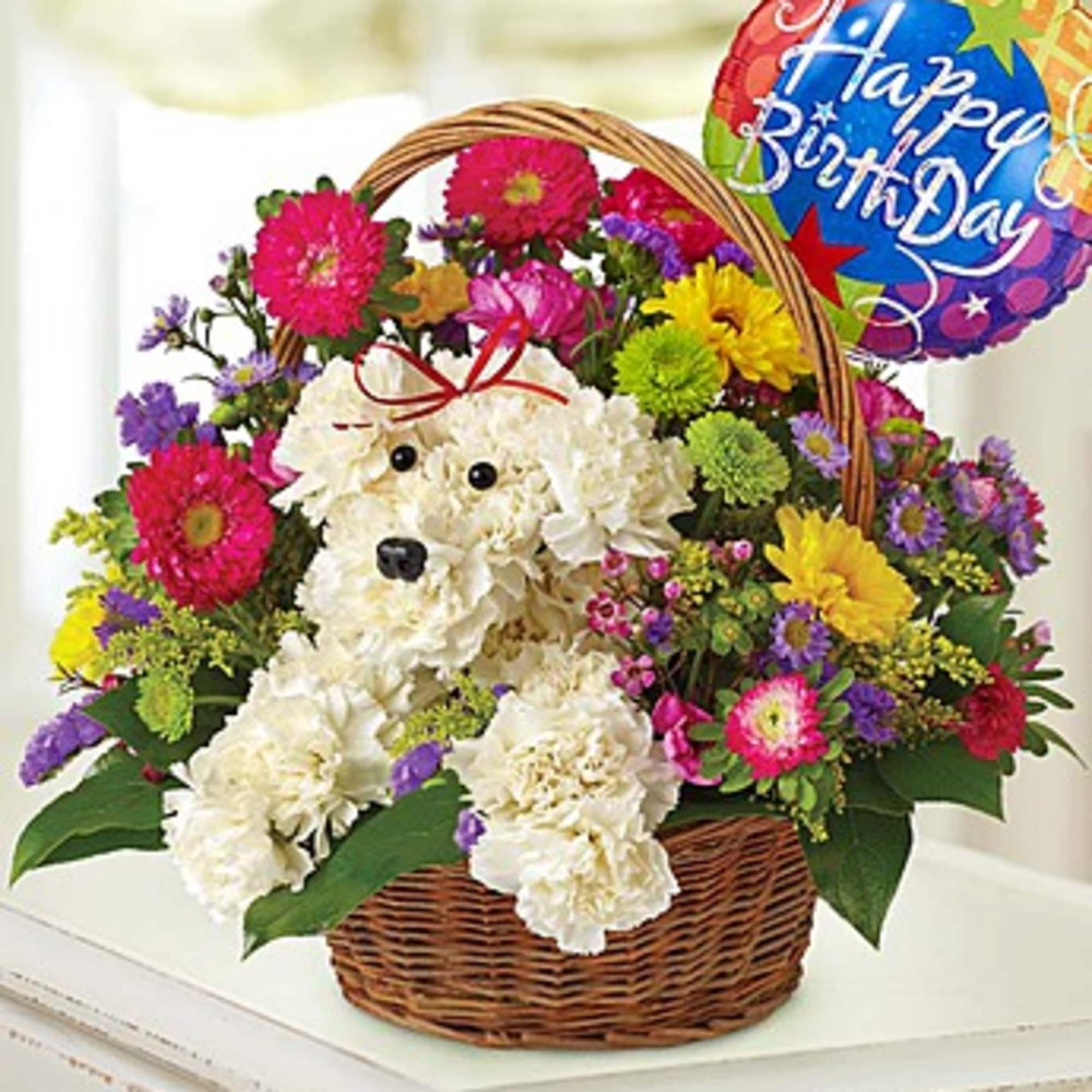 Flower basket with a plush white dog and a birthday balloon