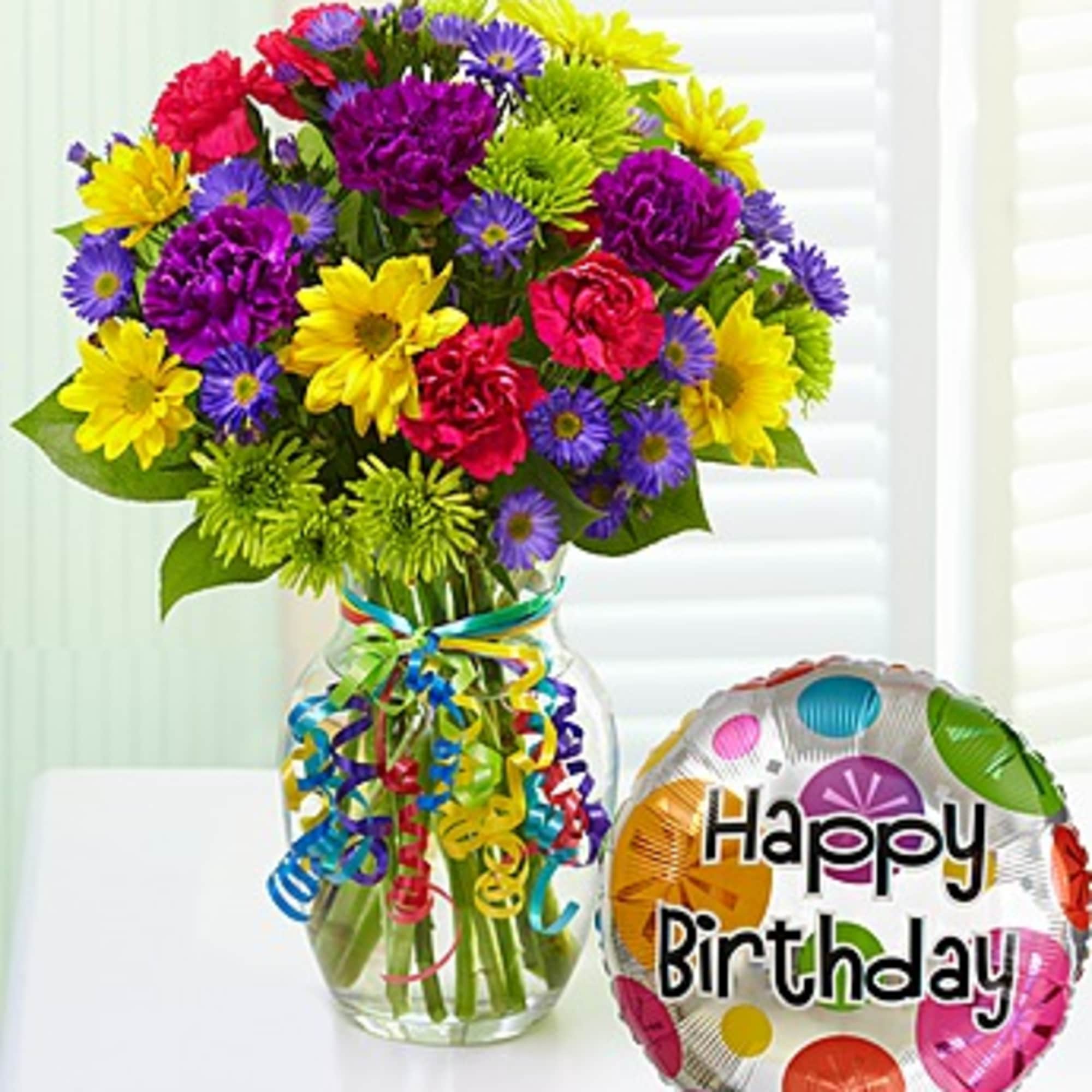 Colorful bouquet in a glass vase with a Happy Birthday balloon