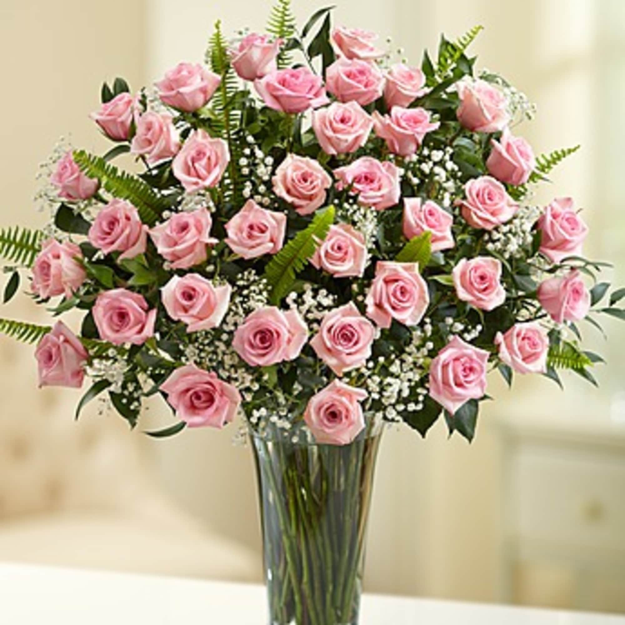 Pink roses arranged in a clear glass vase