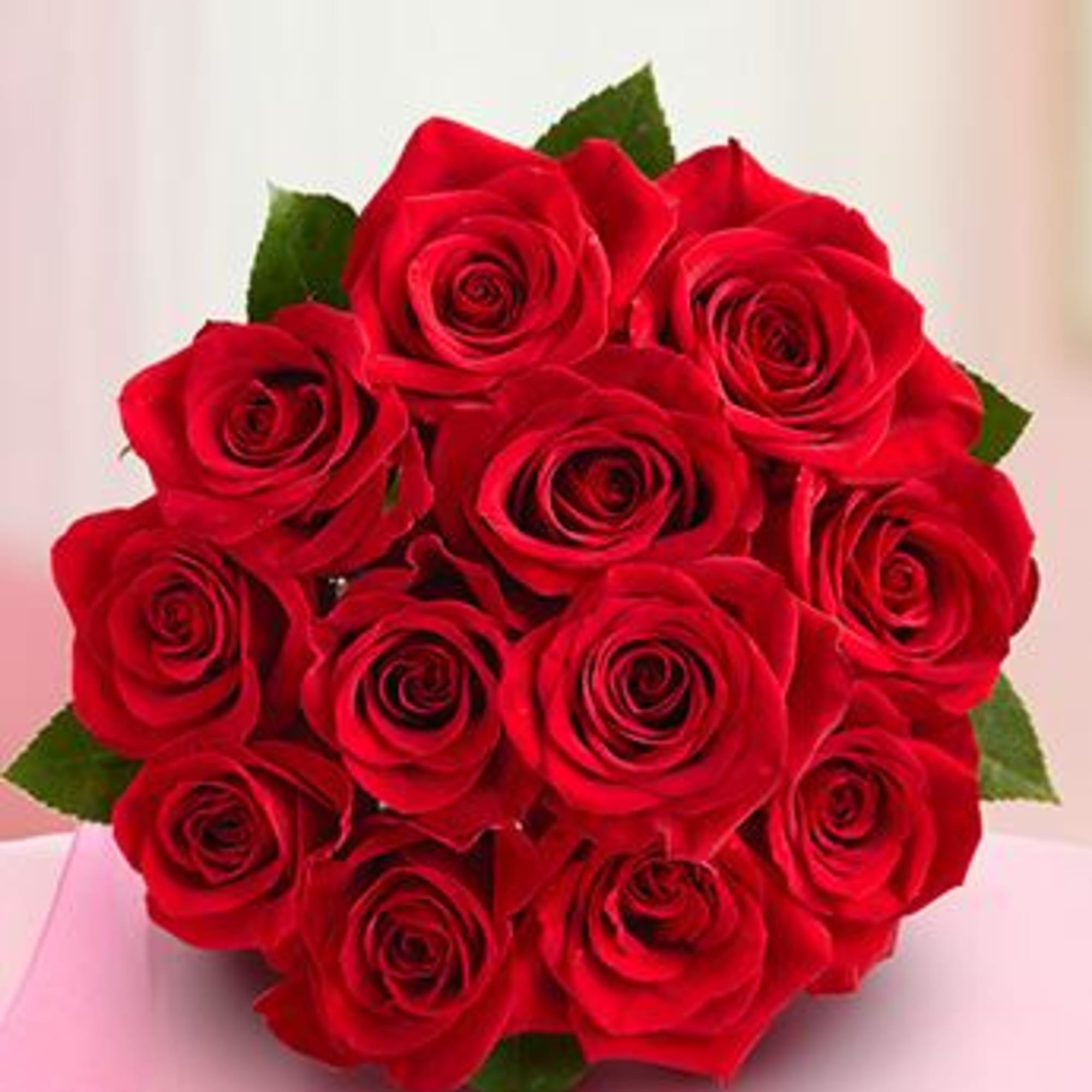 Bouquet of red roses with green leaves