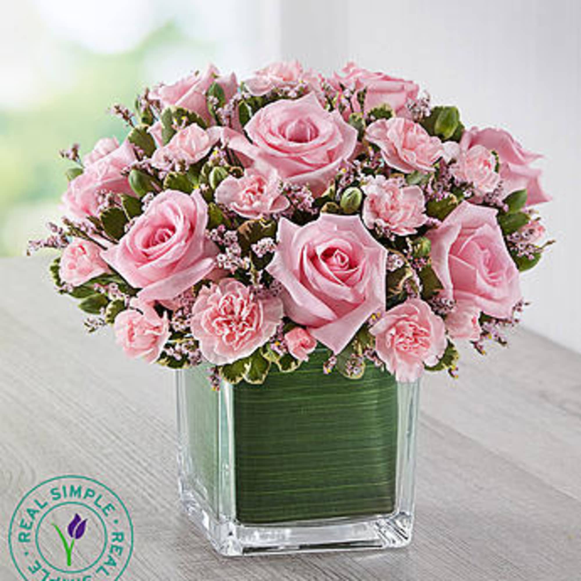 Pink roses and carnations in a clear square vase, photo 2 of 3