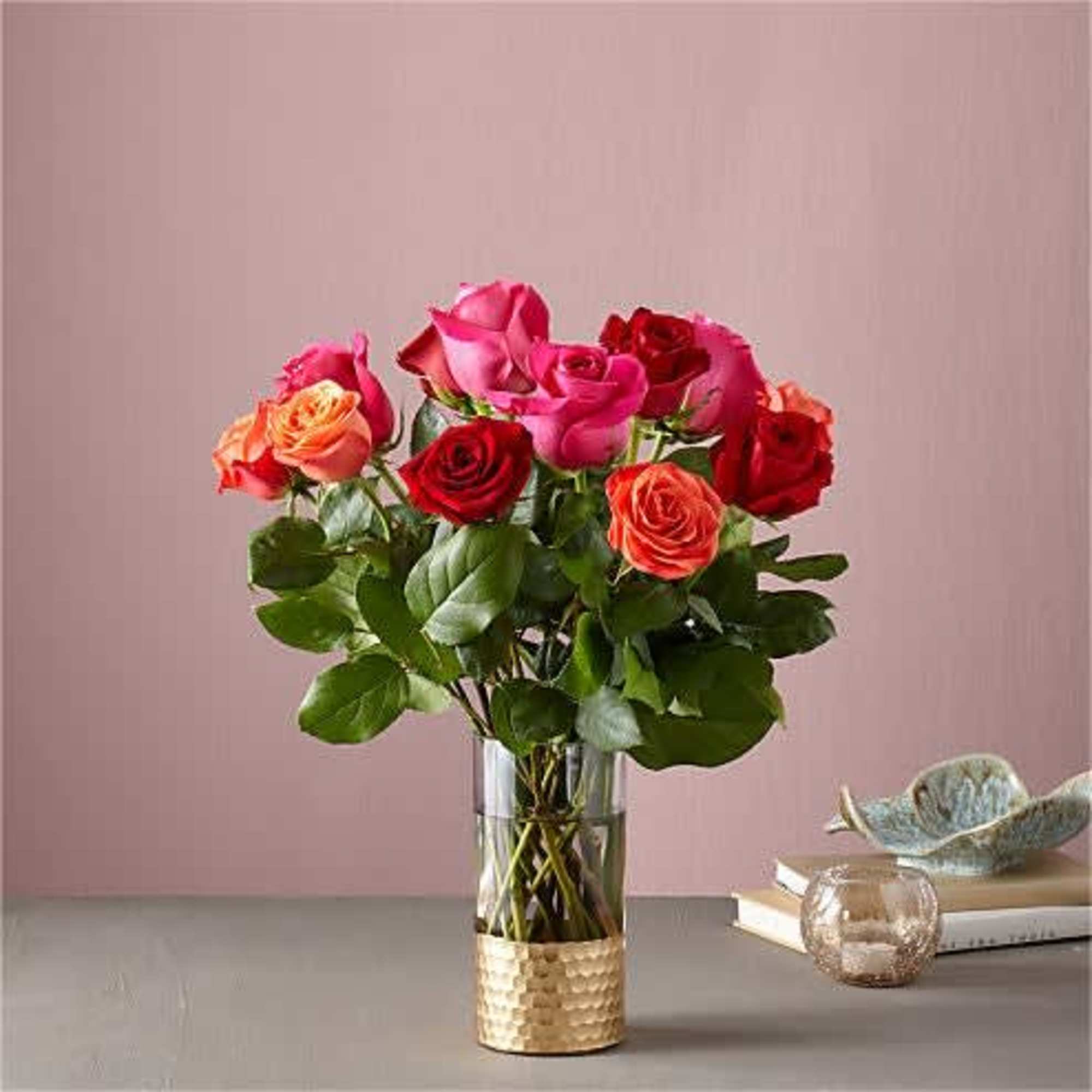 Bouquet of pink and red roses in a clear glass vase