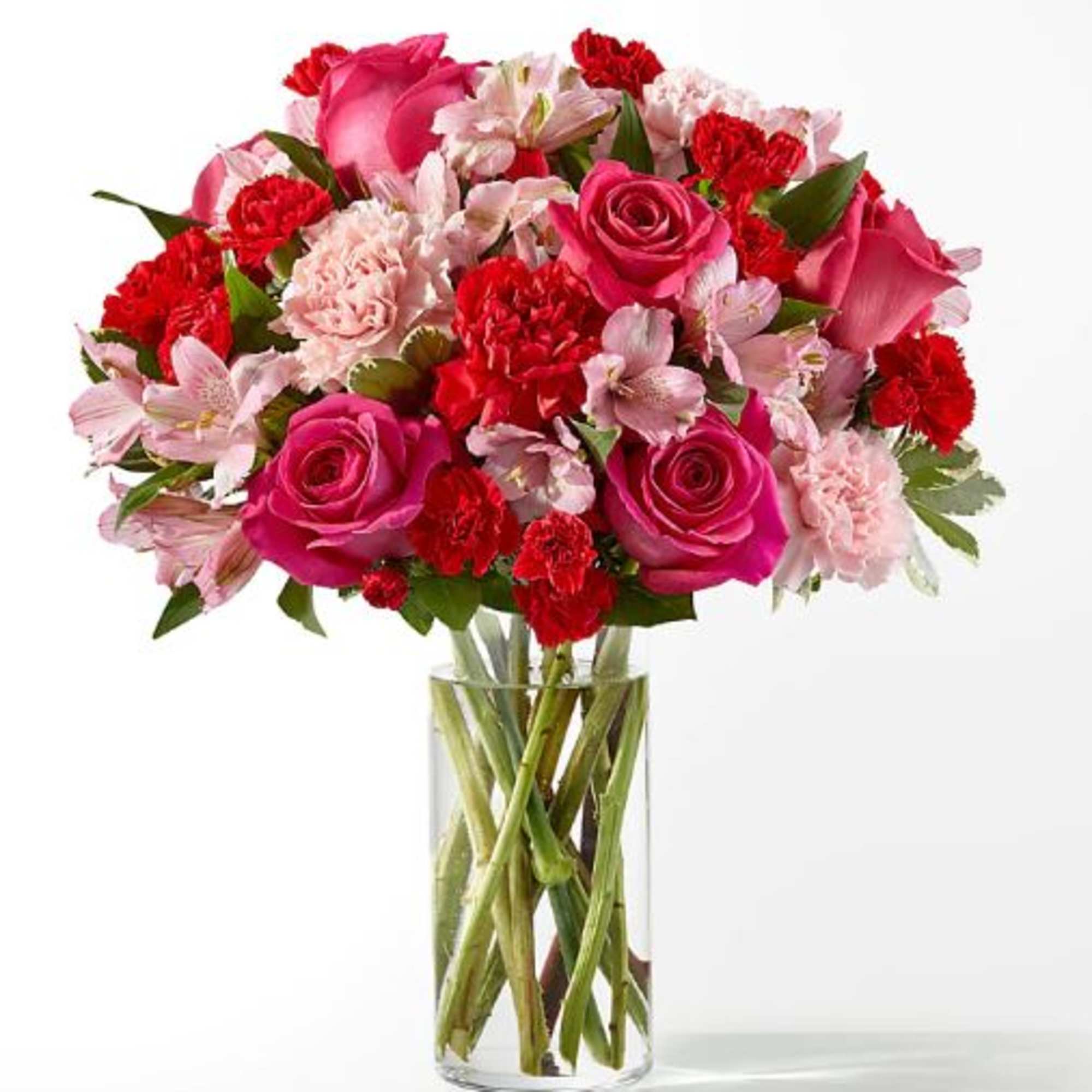 Pink and red mixed bouquet in a clear glass vase