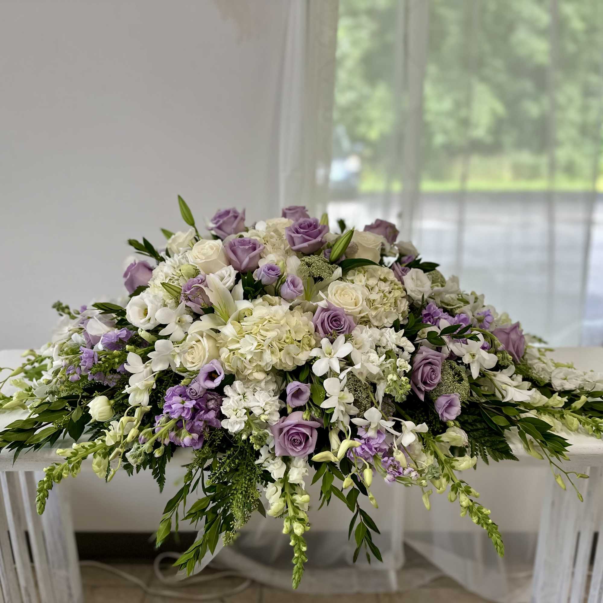 Lavender and white floral arrangement spread across a table
