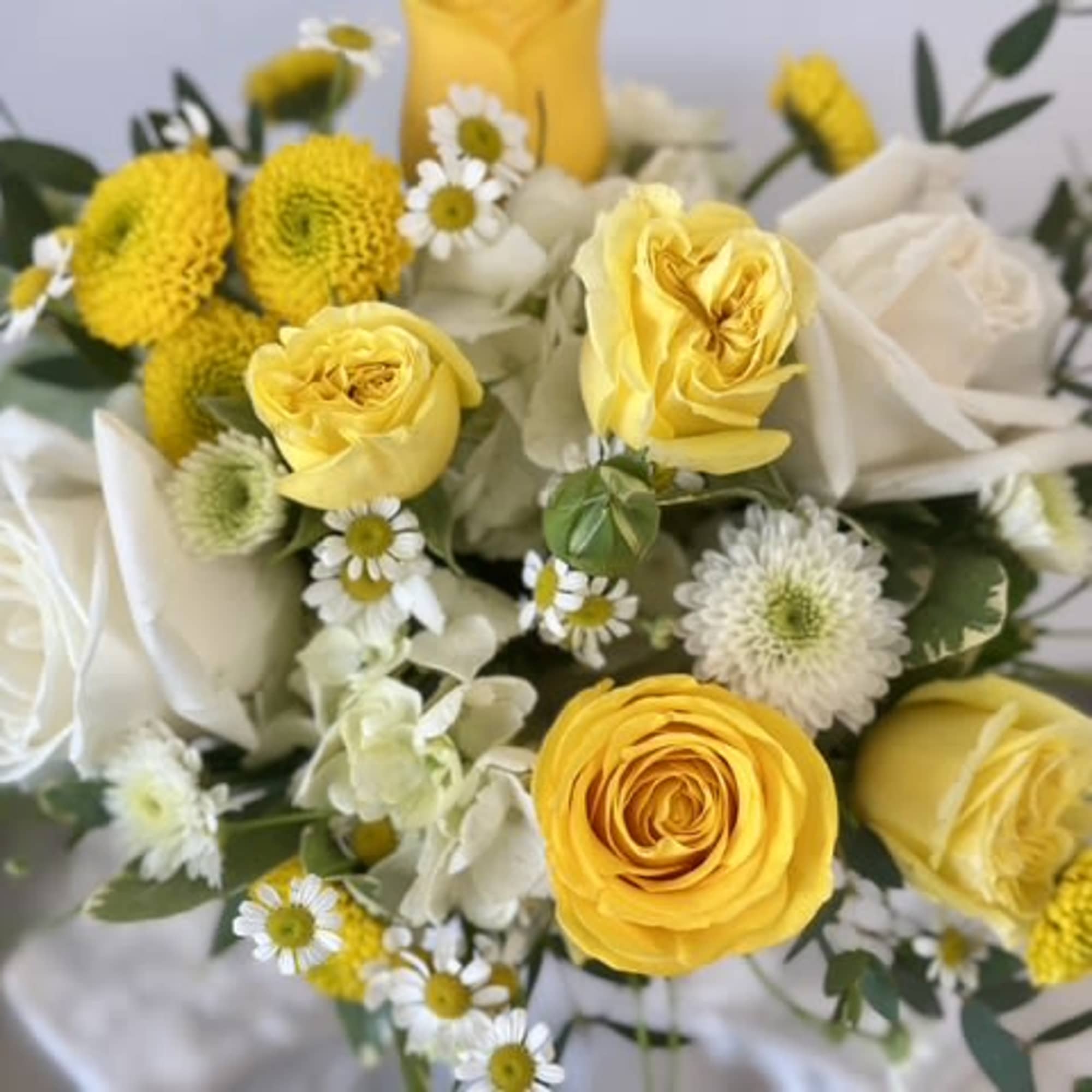 Yellow and white rose bouquet with small daisy-like flowers