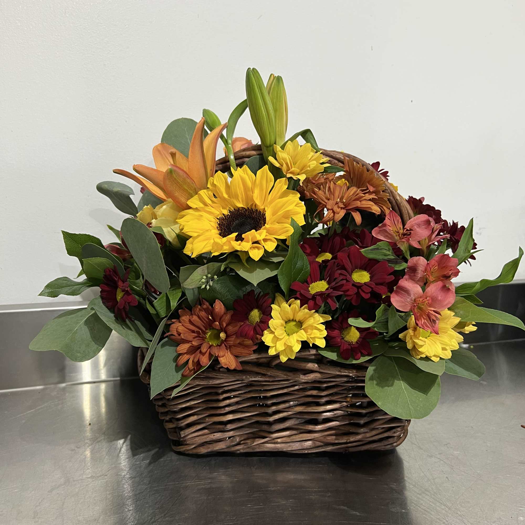 Gorgeous shades of fall. Sunflowers, lilies, spray roses, and assorted daisy poms., photo 2 of 3