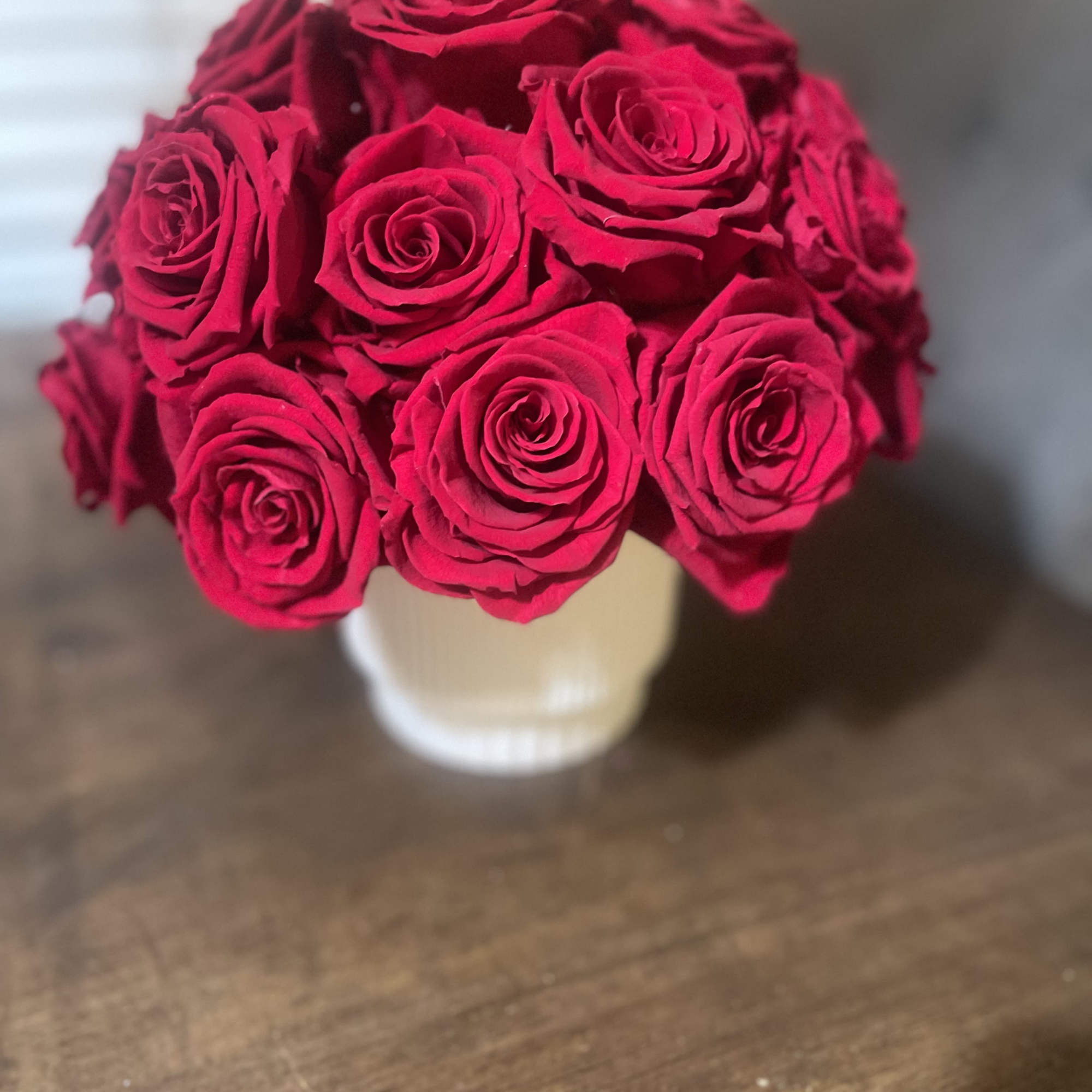 Bouquet of bright red roses in a white vase