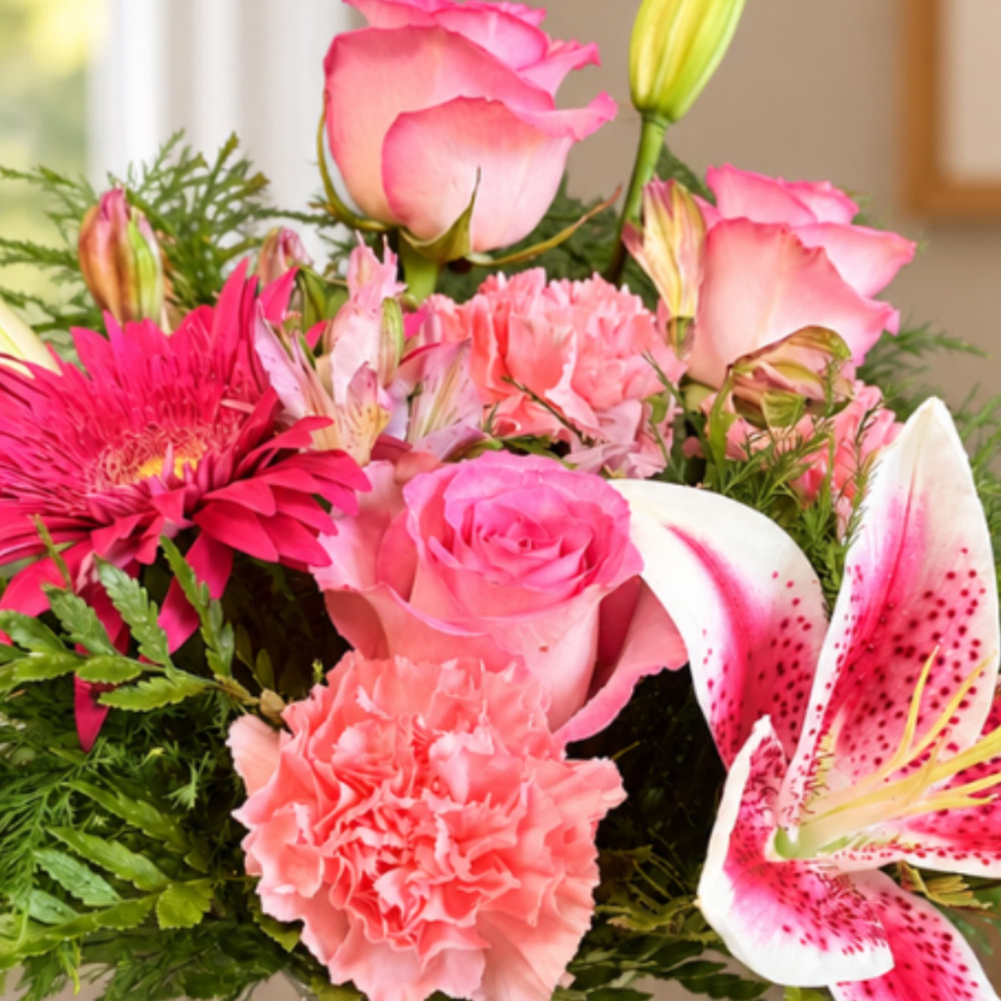 Pink roses, lilies, and carnations in a mixed bouquet