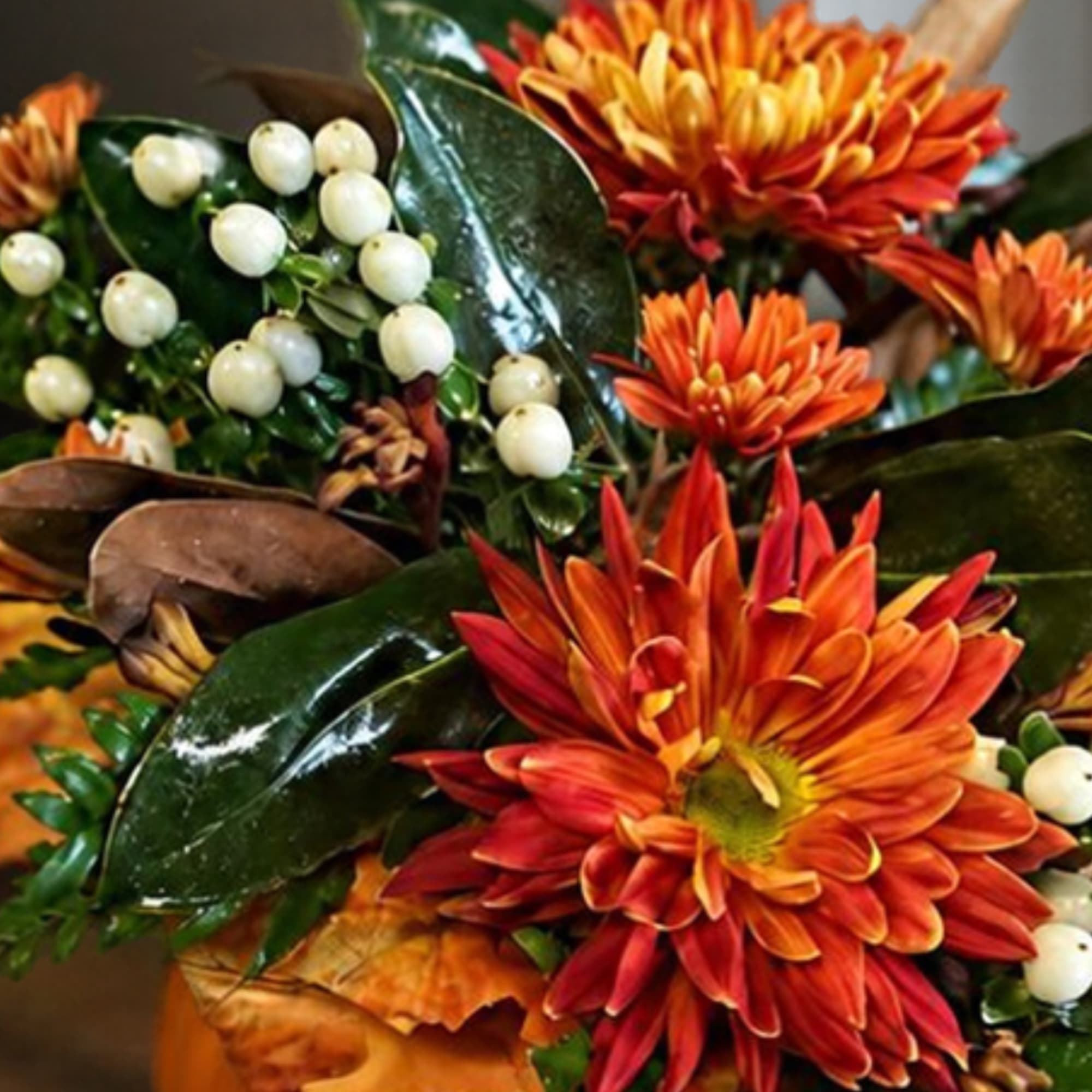 Orange chrysanthemum bouquet with white berry accents