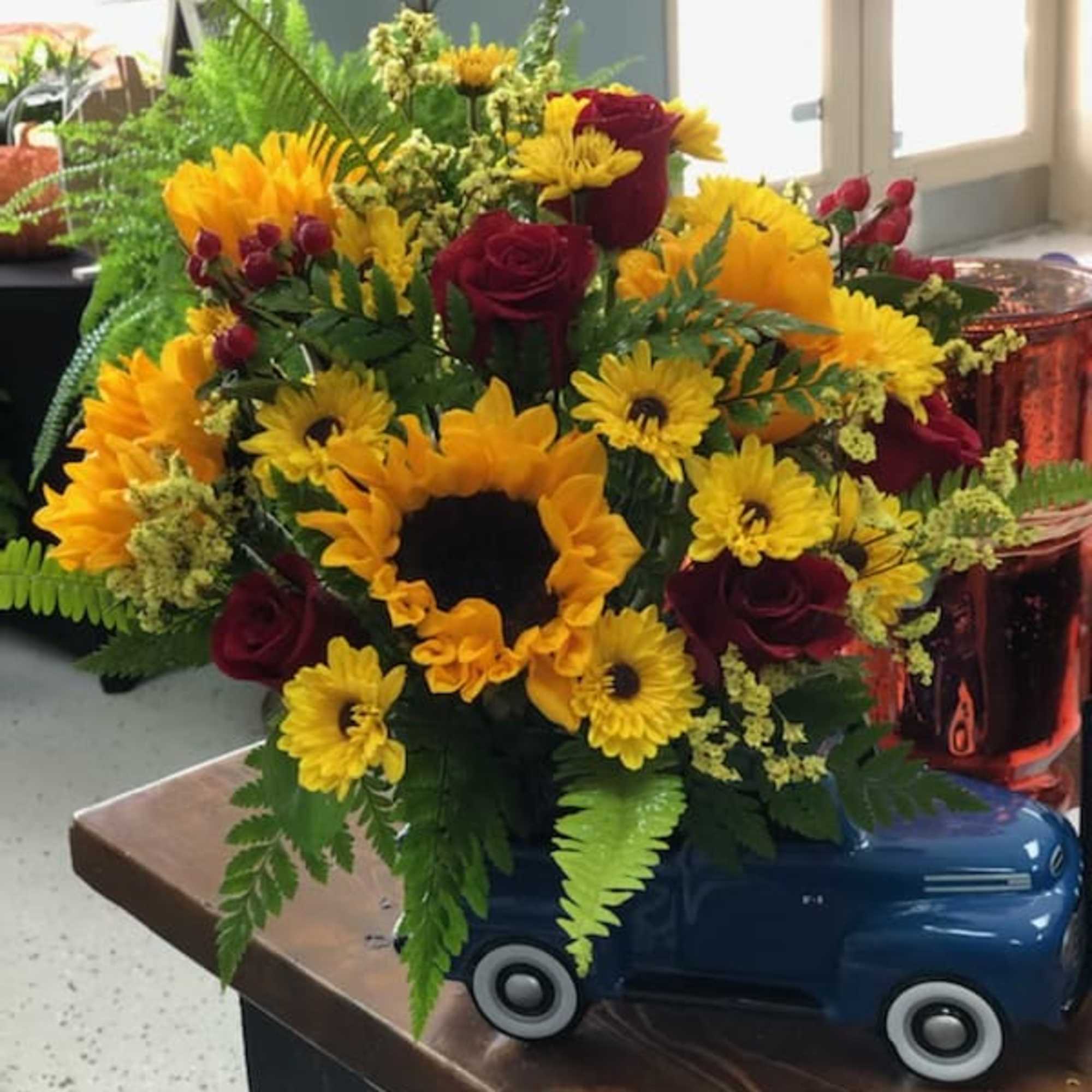 Ford truck with sunflowers and red roses