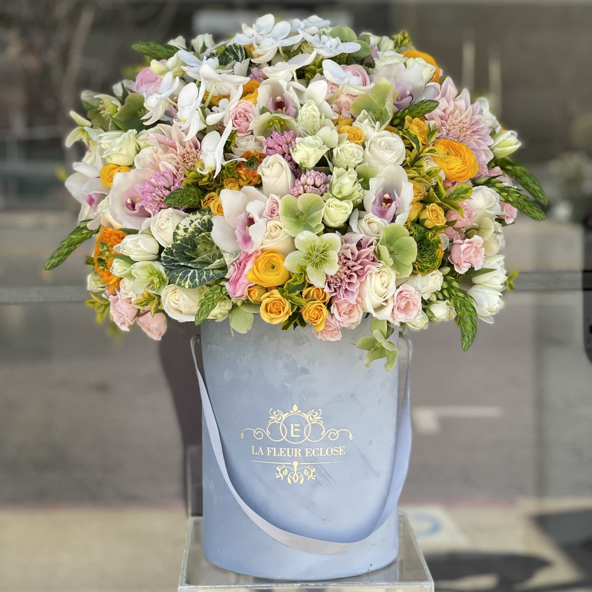 Large pastel bouquet in a blue hatbox with white and pink flowers