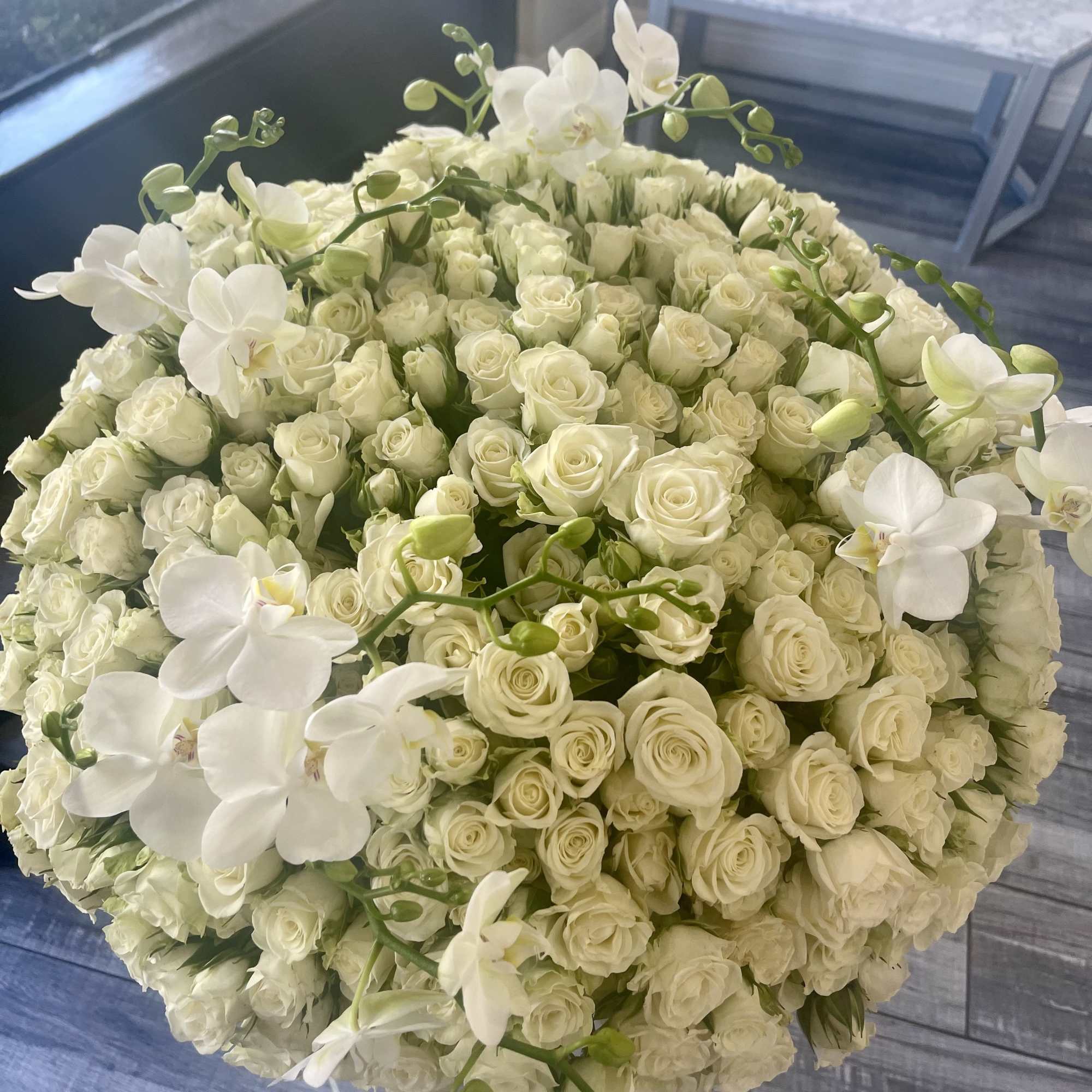 Round bouquet of white roses and white orchids