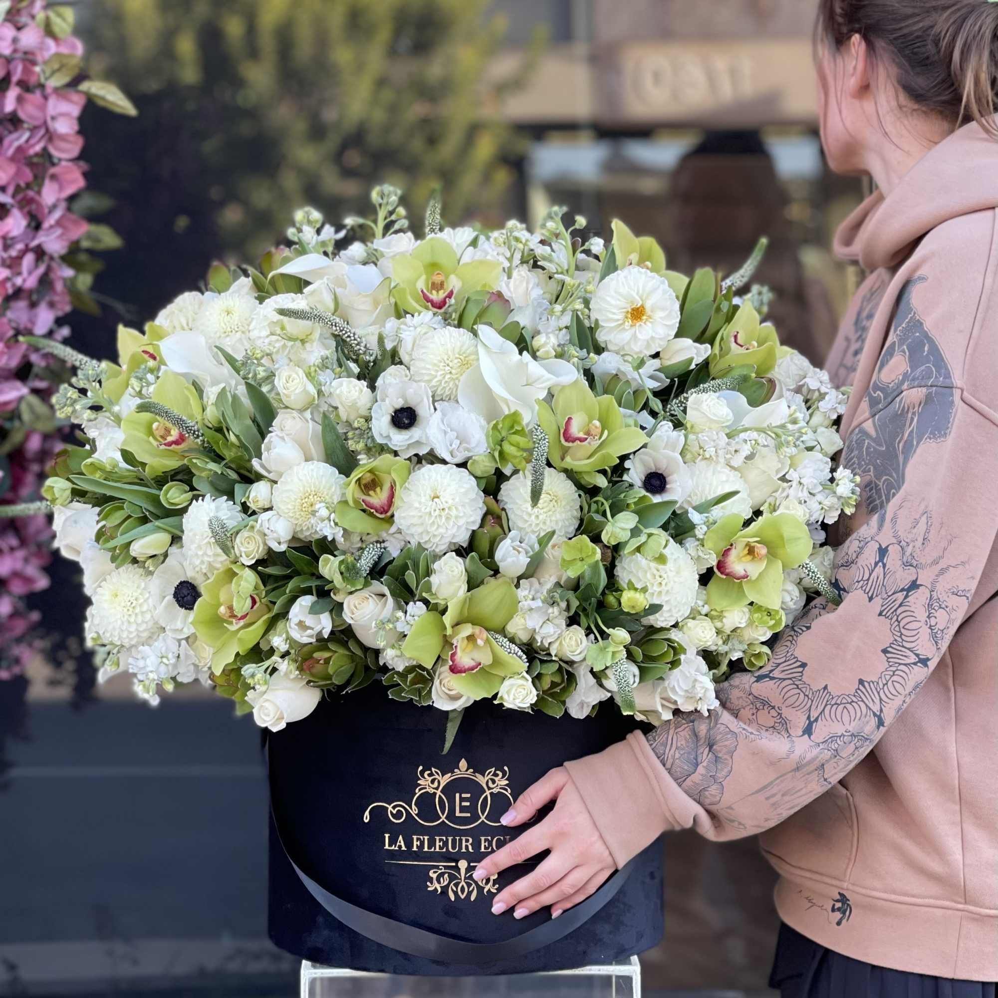 Large white and green floral arrangement in a black hatbox, photo 2 of 3