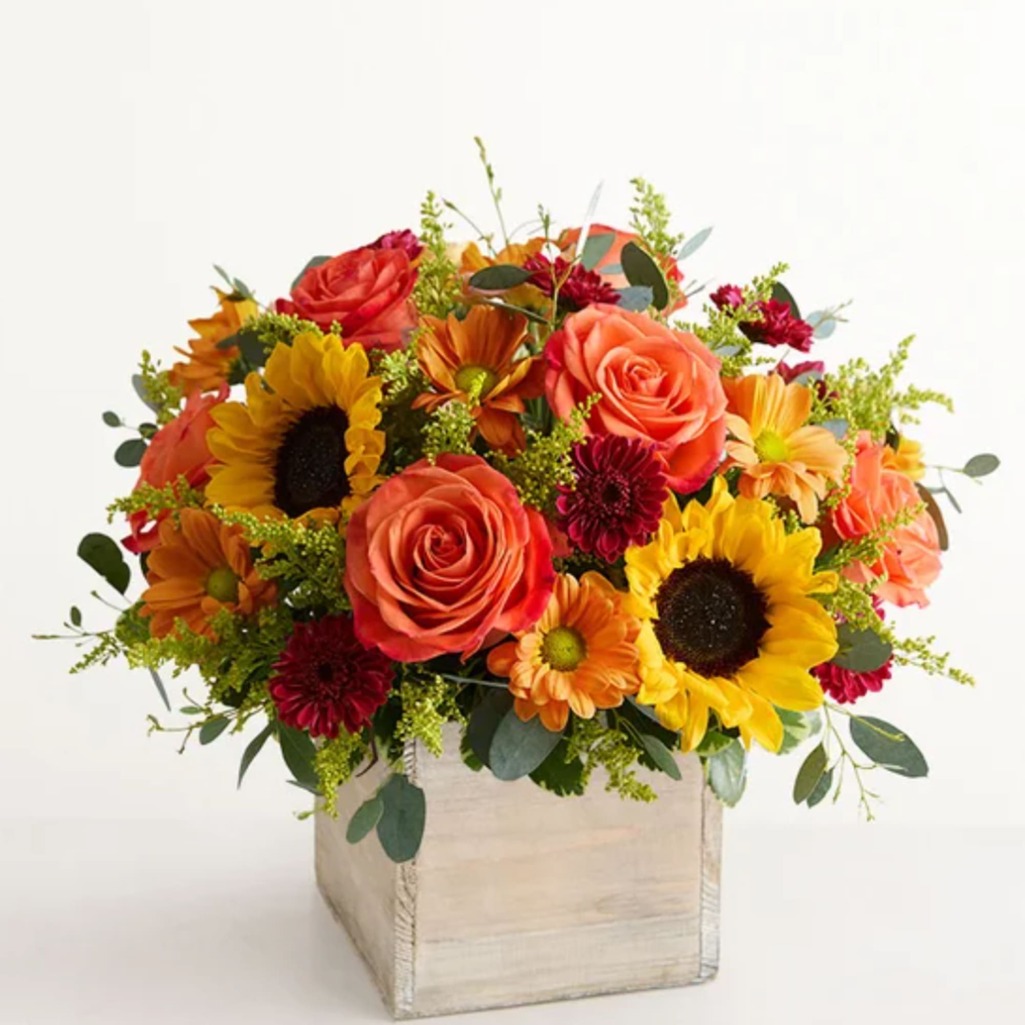 Mixed bouquet of roses, sunflowers, and daisies in a wooden box