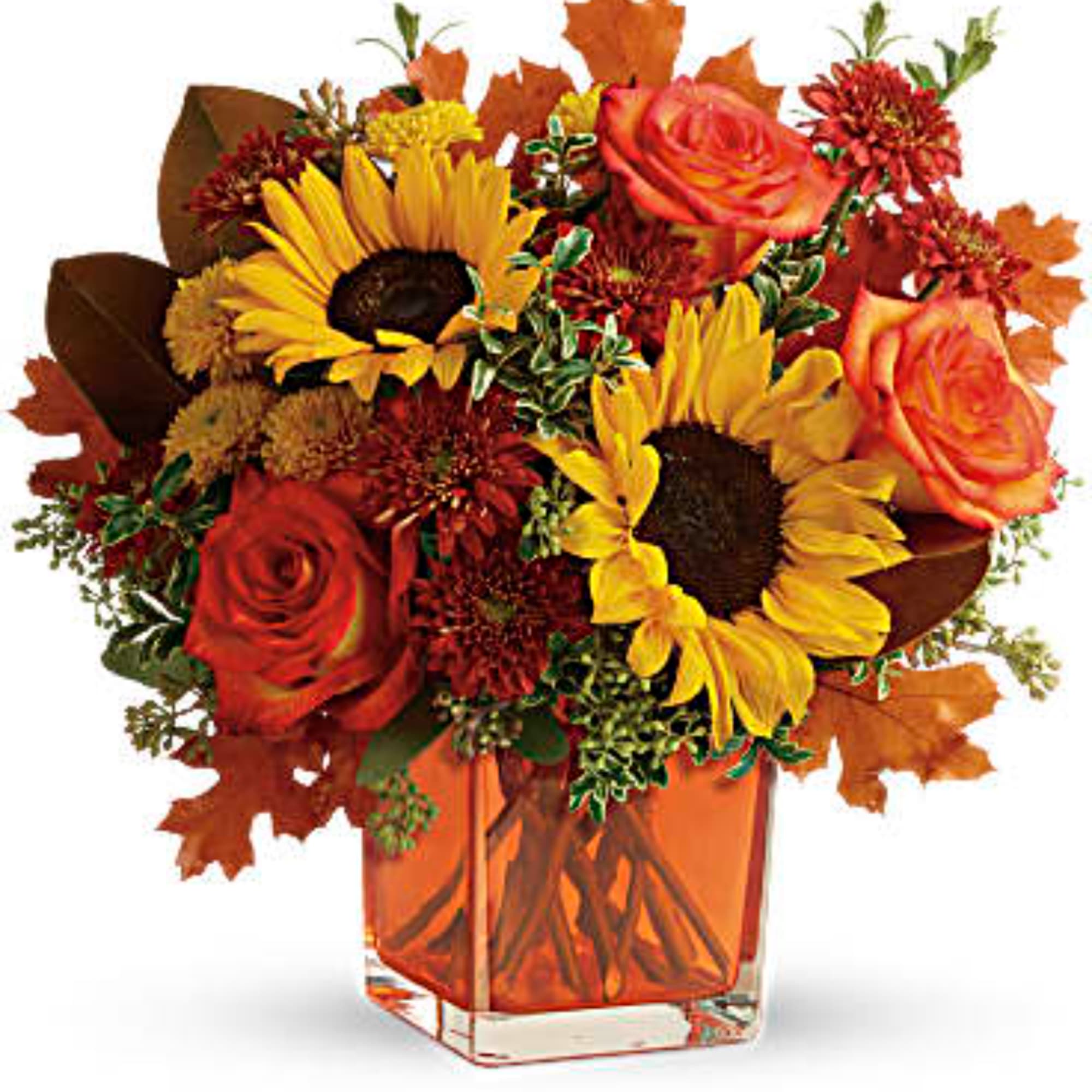 Autumn bouquet of sunflowers and orange roses in a square glass vase