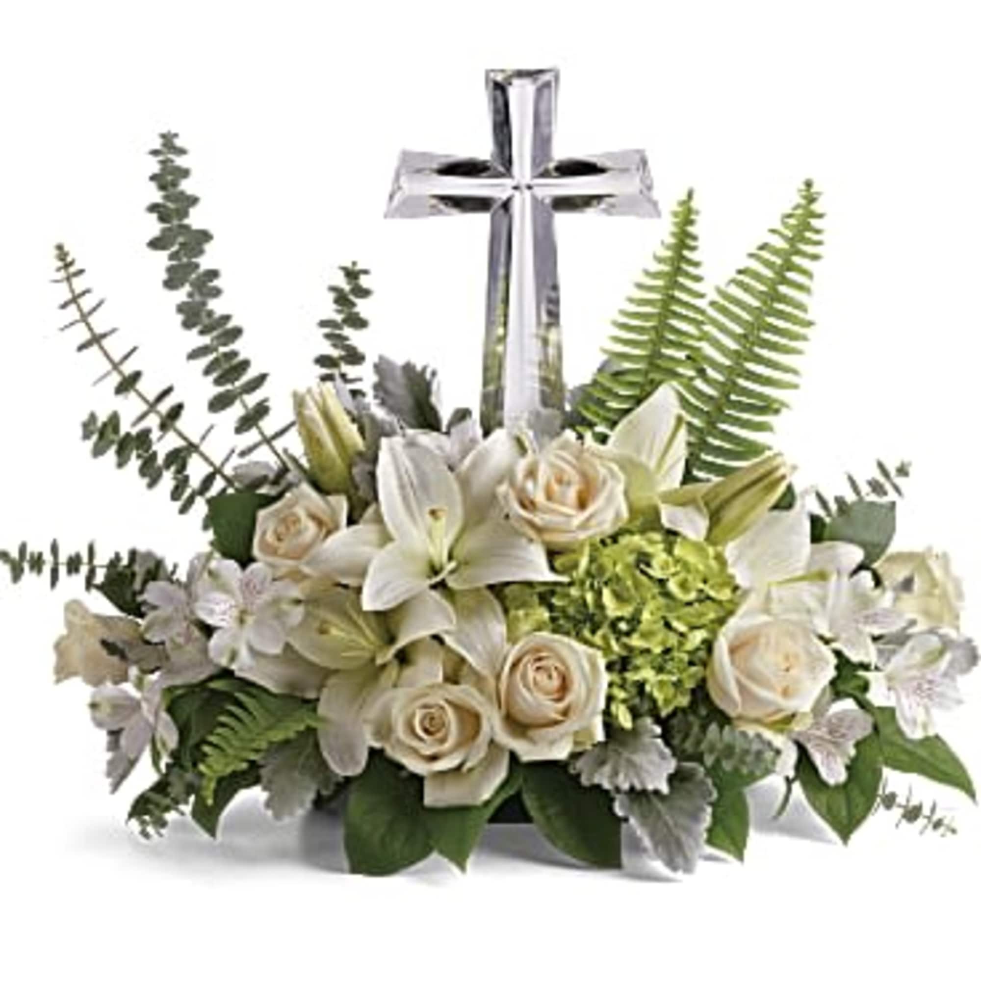 White floral arrangement with a silver cross centerpiece