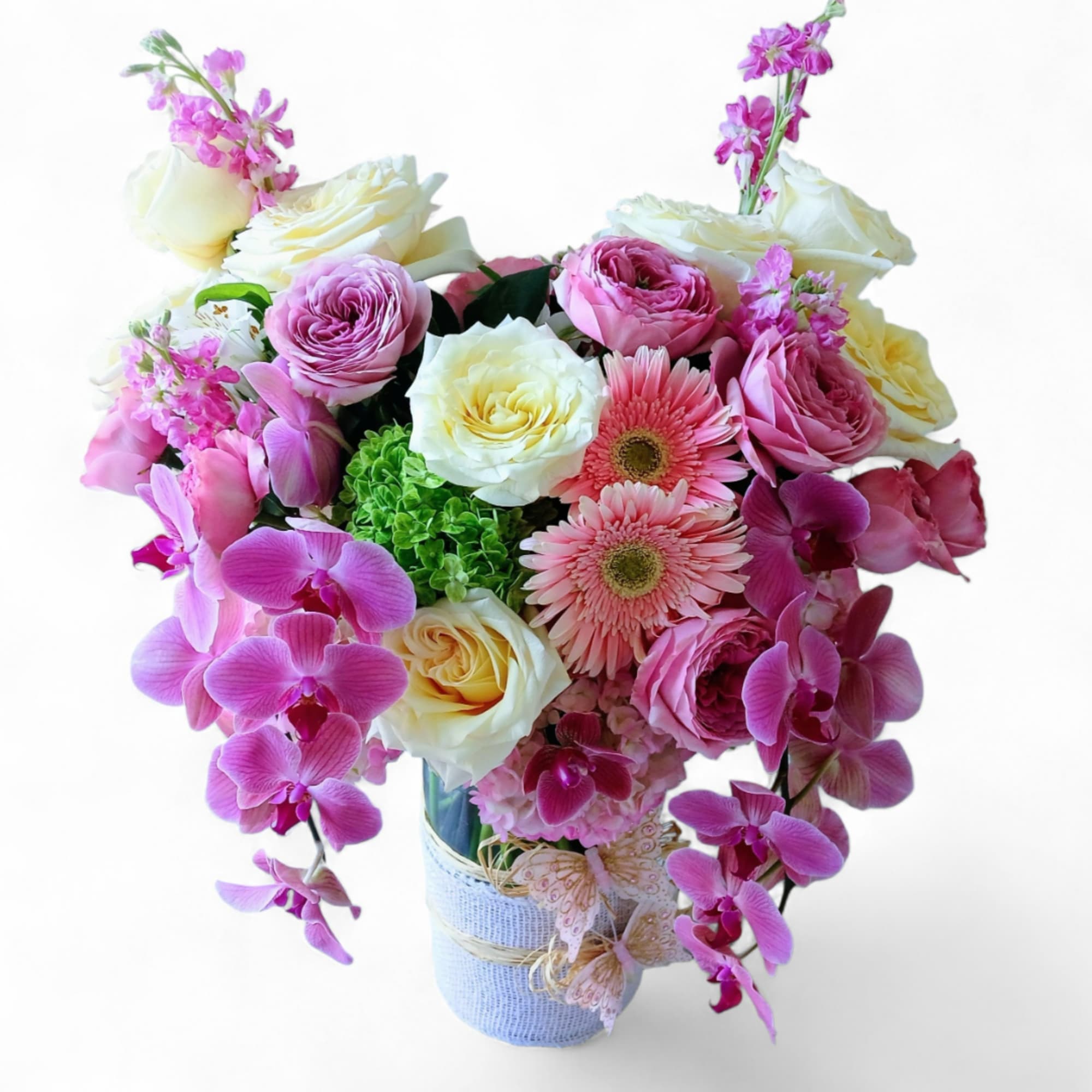 Pink and white mixed bouquet in a wrapped vase with orchids and roses