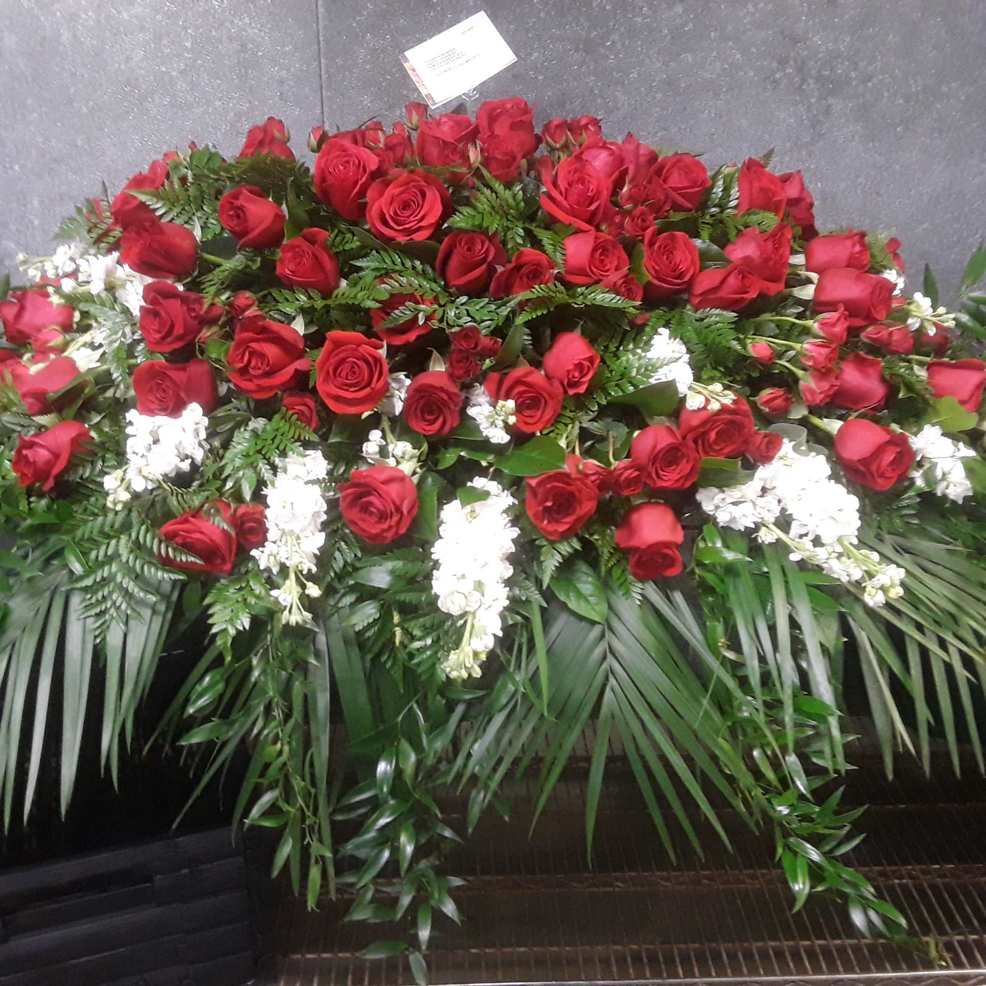 6 feet casket spray with roses, and white delphiniums and stock with