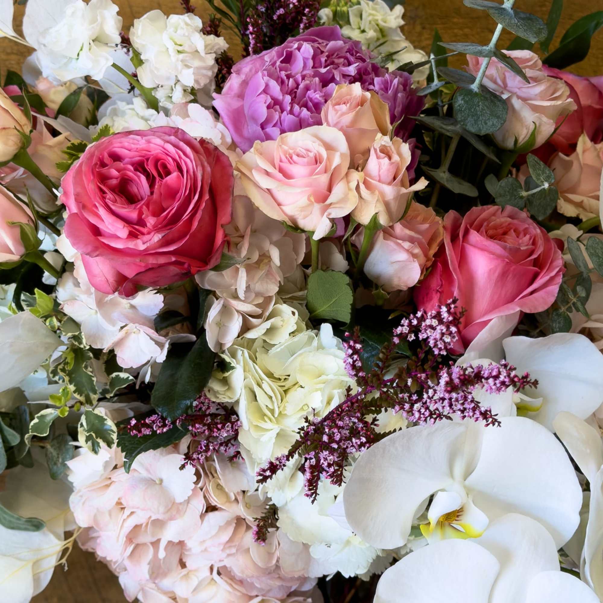 Bouquet of pink and white roses with orchids and hydrangea