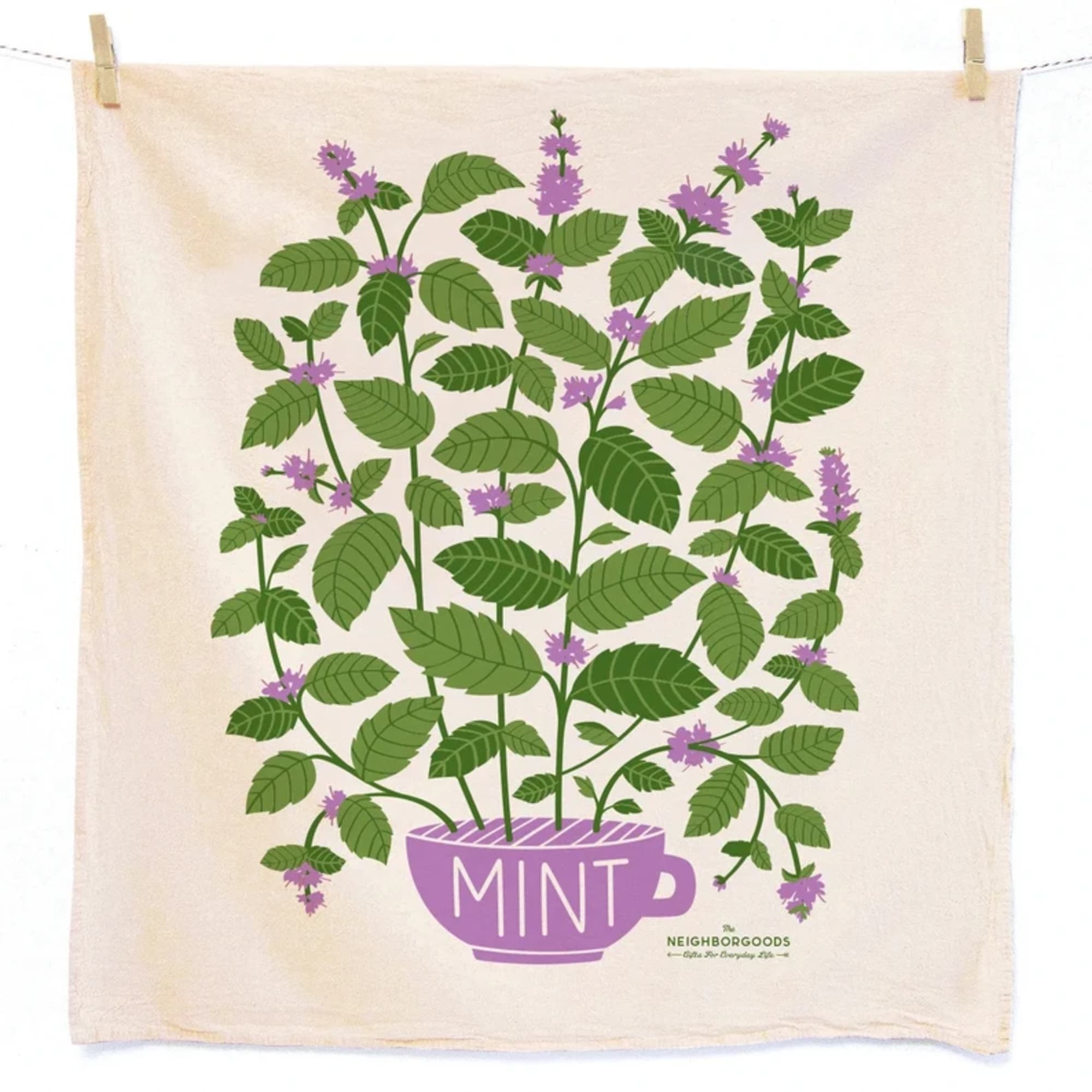Tea towel with illustrated green mint plant growing from a purple cup on a cream background