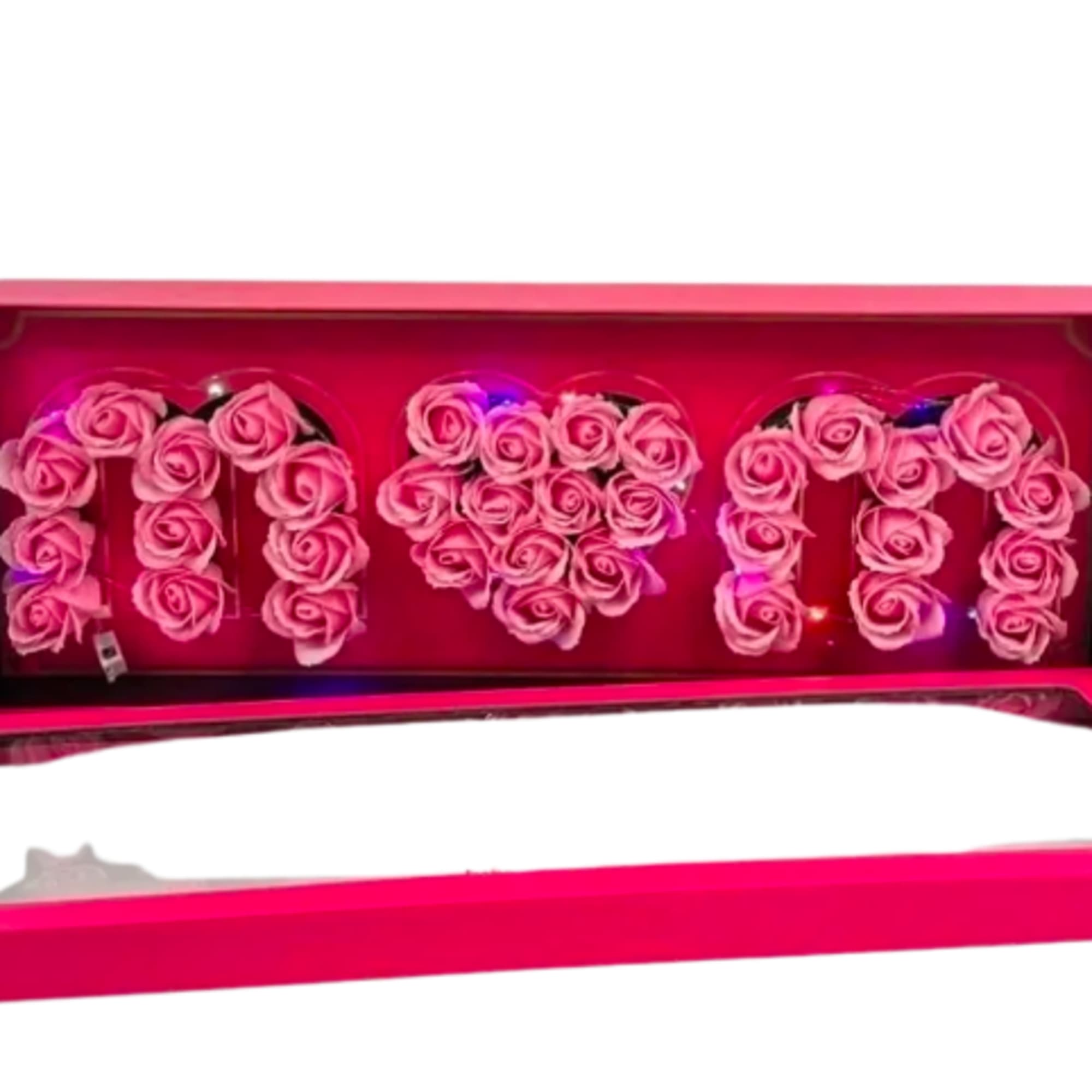 Pink box of roses spelling MOM with a heart shape in the center and small colored lights inside