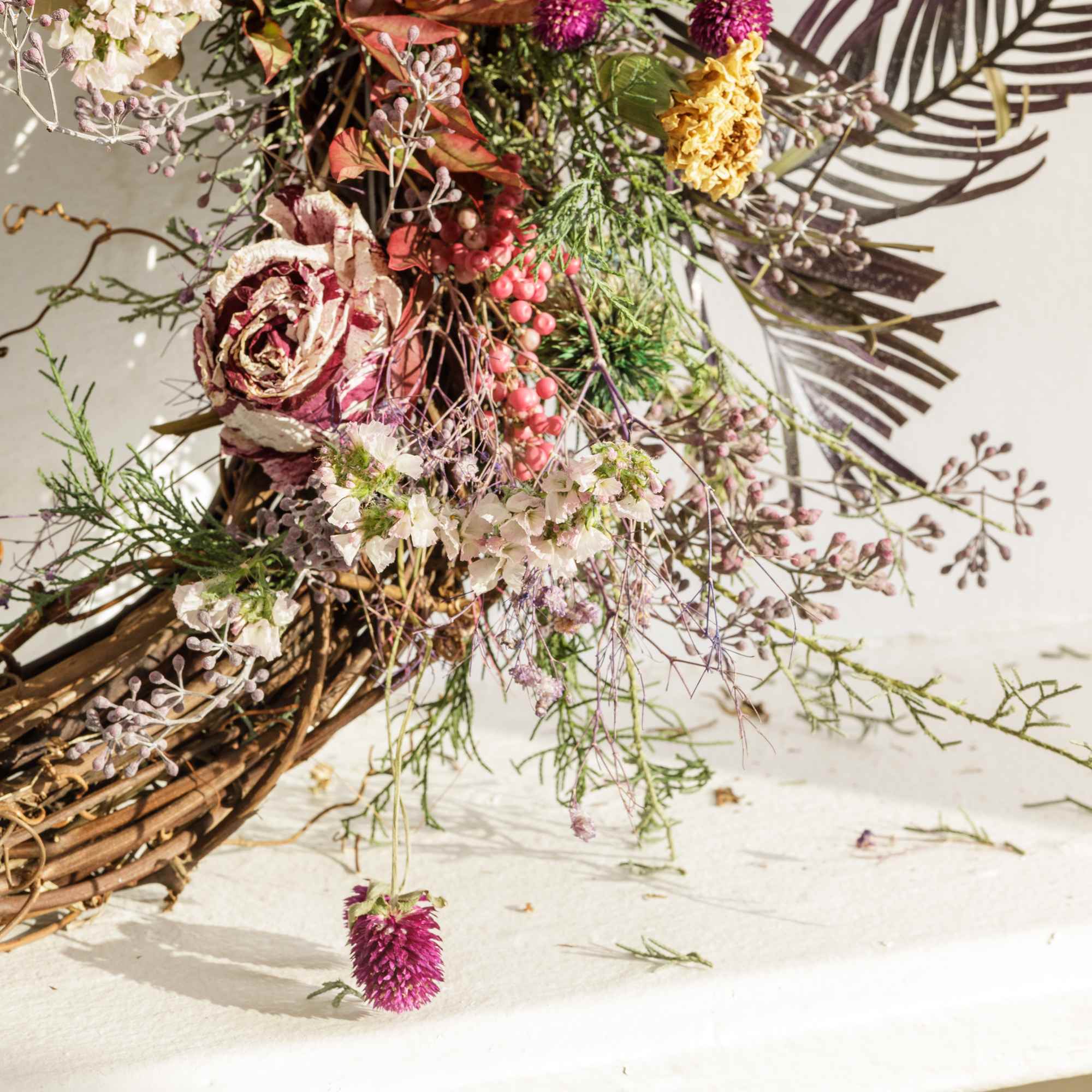 Wildflower bouquet with pink and white blooms in a woven base
