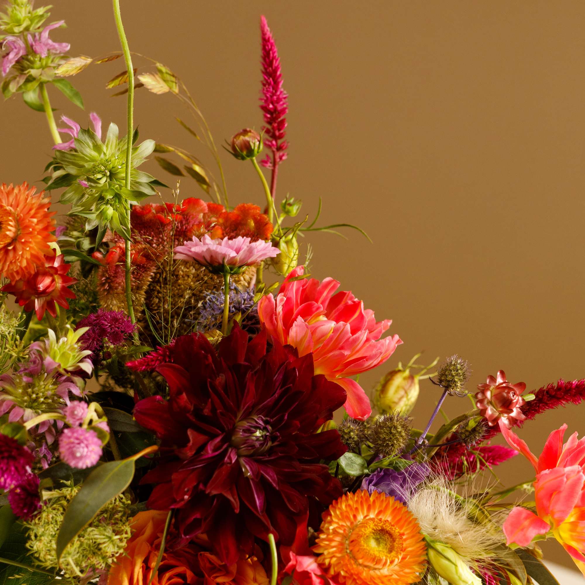 Colorful mixed flower arrangement in a speckled vase