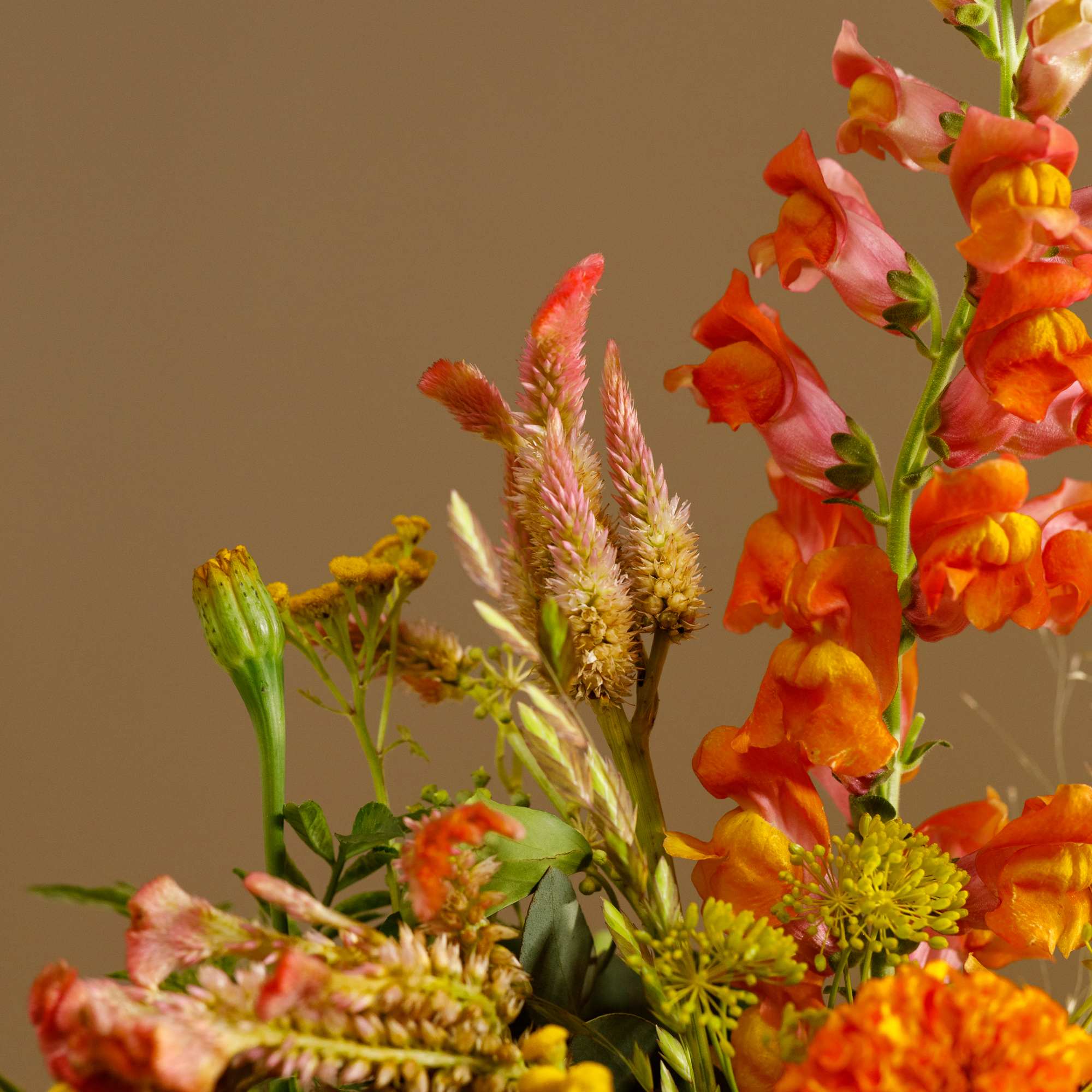 Orange snapdragons and mixed yellow flowers in a bouquet