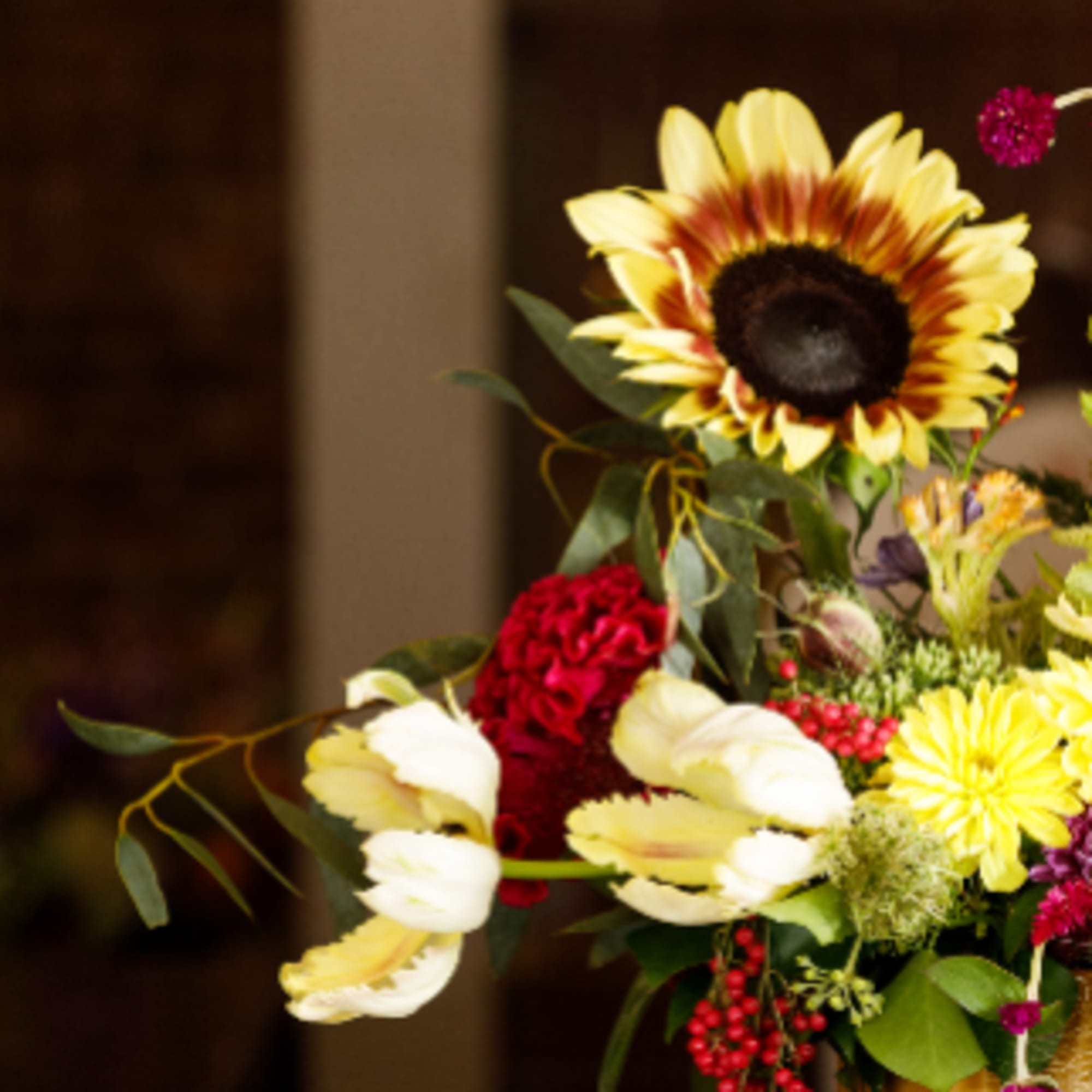 Mixed bouquet with a large yellow sunflower and pale tulips