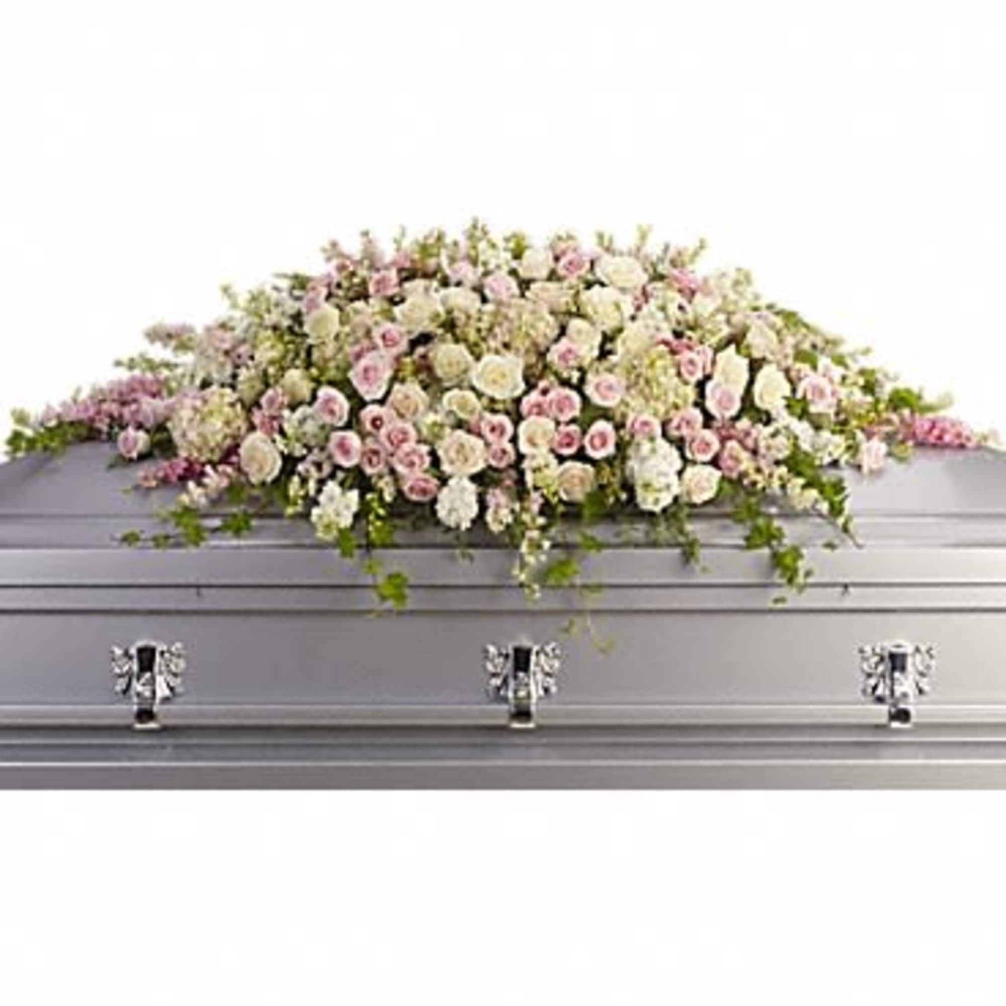 Large pastel floral spray on a silver casket