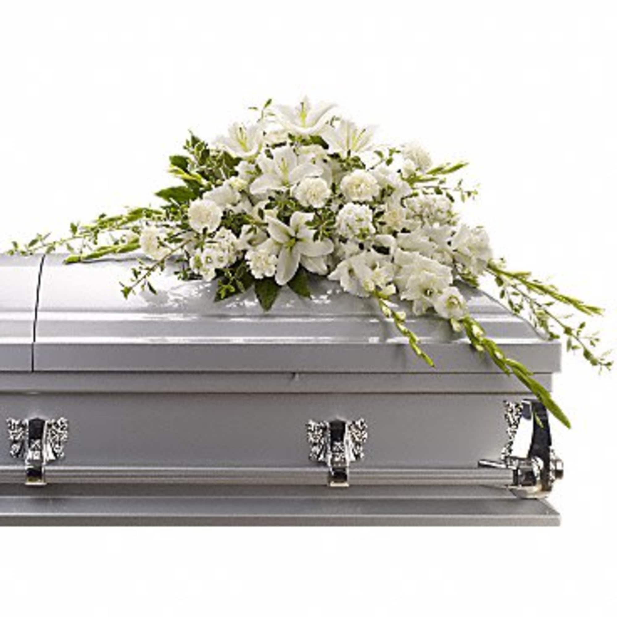 White floral spray on a silver casket